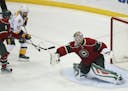 Minnesota Wild goalie Devan Dubnyk (40) stopped a shot in the third period that Predators center Mike Fisher (12) was trying to deflect as the Wild's 