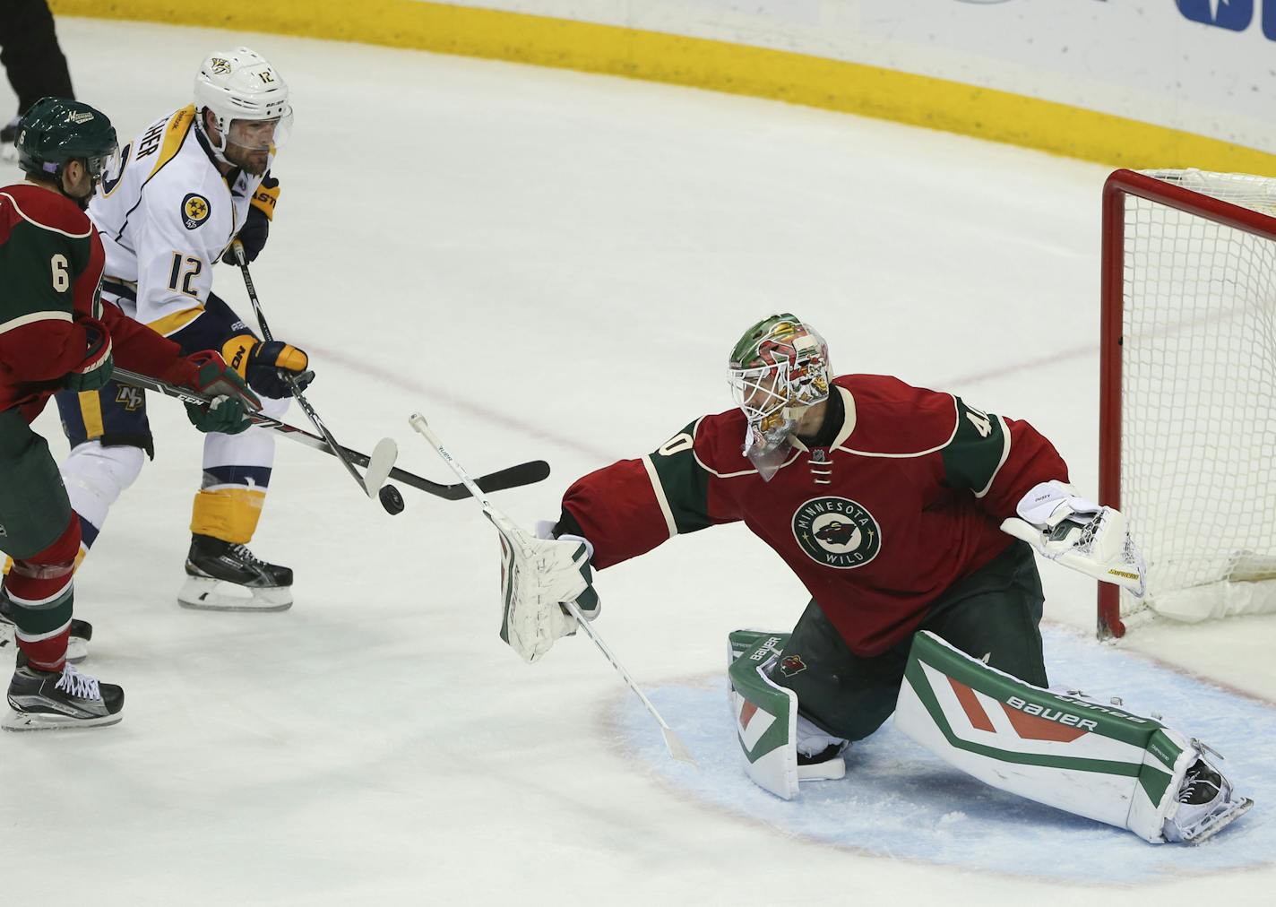 Minnesota Wild goalie Devan Dubnyk (40) stopped a shot in the third period that Predators center Mike Fisher (12) was trying to deflect as the Wild's Marco Scandella (6) defended Thursday night. ] JEFF WHEELER &#xef; jeff.wheeler@startribune.com The Minnesota Wild lost 3-2 to the Nashville Predators in an NHL hockey game Thursday night, November 5, 2015 at Xcel Energy Center in St. Paul.