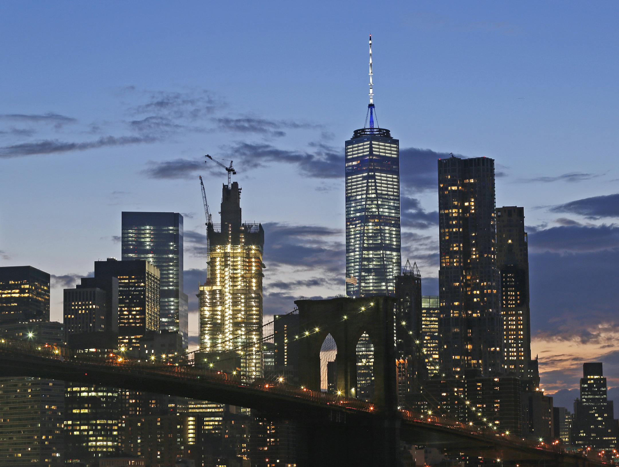In this Aug. 19, 2016 photo, the lower Manhattan skyline, including One World Trade Center and the Brooklyn Bridge, are shown in New York.