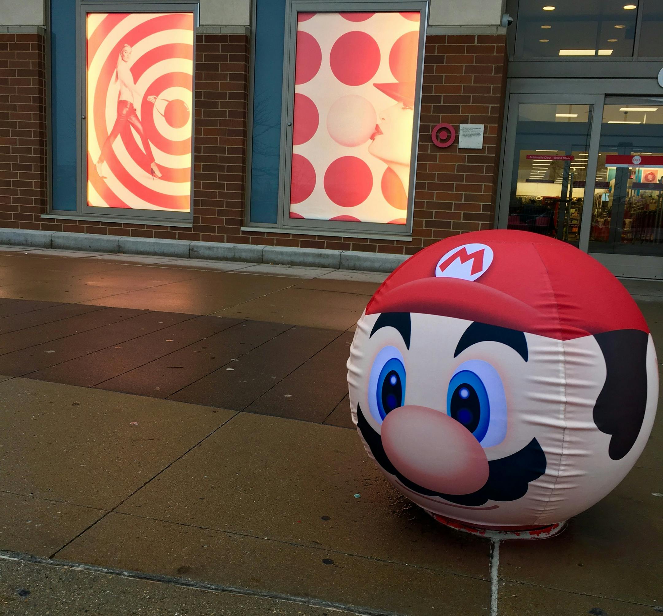 The bollards outside the stores are decorated as characters from Super Mario games.