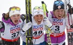 Winner Sweden's Charlotte Kalla, center, celebrates besides second placed United States' Jessica Diggins, left, and third placed United States' Caitli