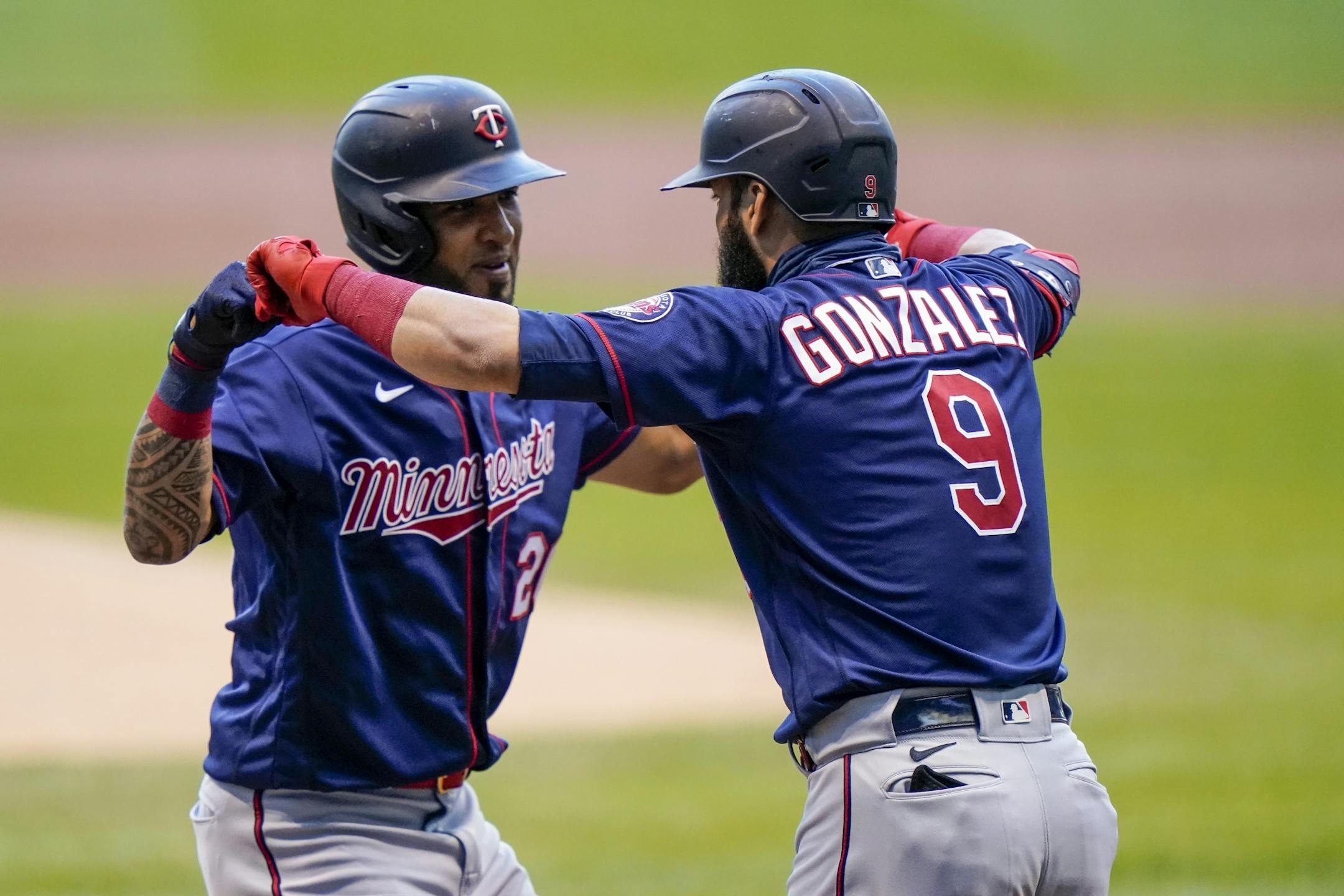 Minnesota Twins' Eddie Rosario is congratulated by Marwin Gonzalez (9) after hitting a home run during the first inning of a baseball game against the Milwaukee Brewers Tuesday, Aug. 11, 2020, in Milwaukee.
