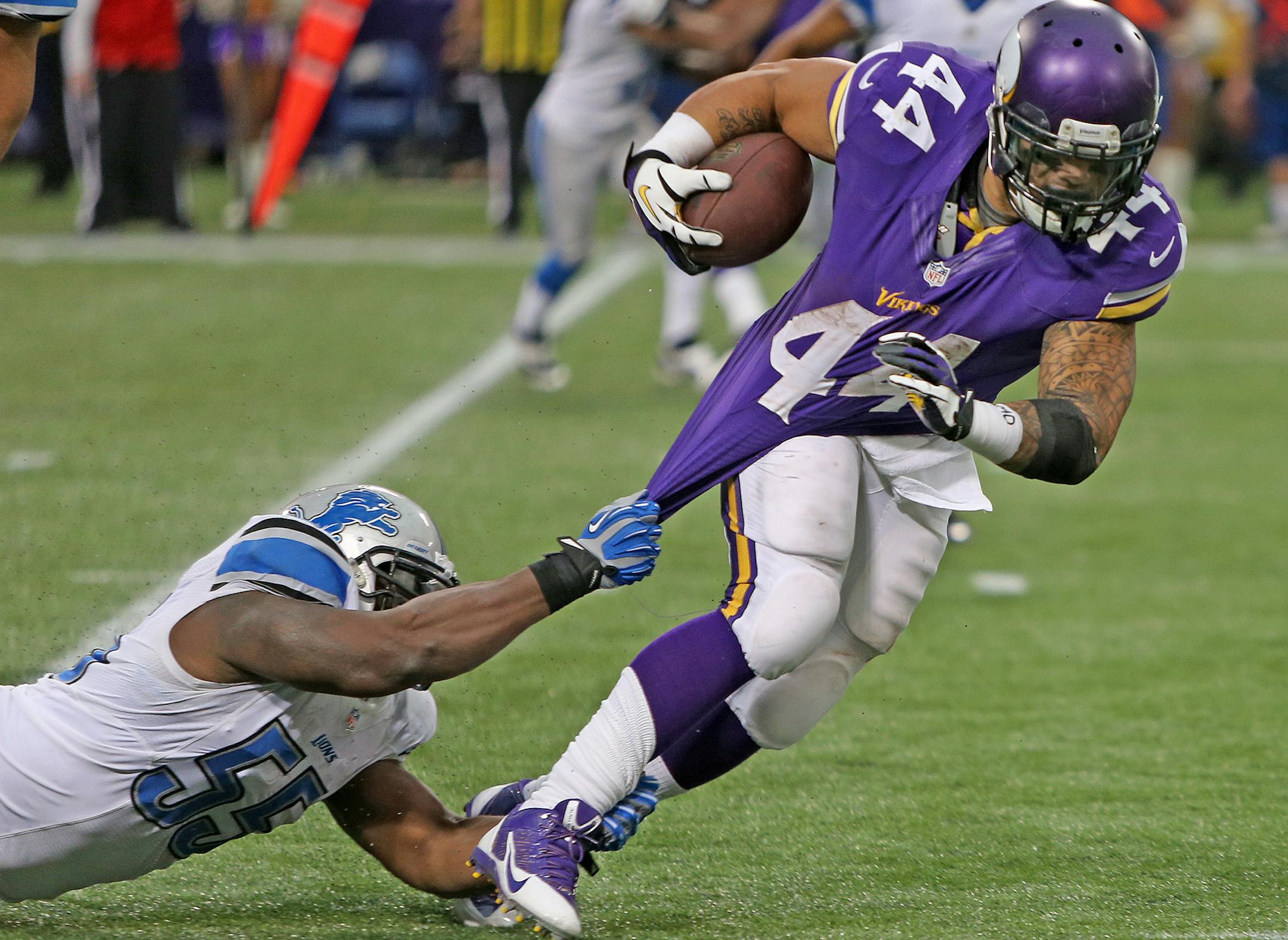 Minnesota Vikings running back Matt Asiata (44) ran for yards as he is held by Detroit Lions middle linebacker Stephen Tulloch (55) in the fourth quarter as the Vikings took on the Lions at Mall of America Field, Sunday, December 29, 2013 in Minneapolis, MN. (ELIZABETH FLORES/STAR TRIBUNE) ELIZABETH FLORES • eflores@startribune.com