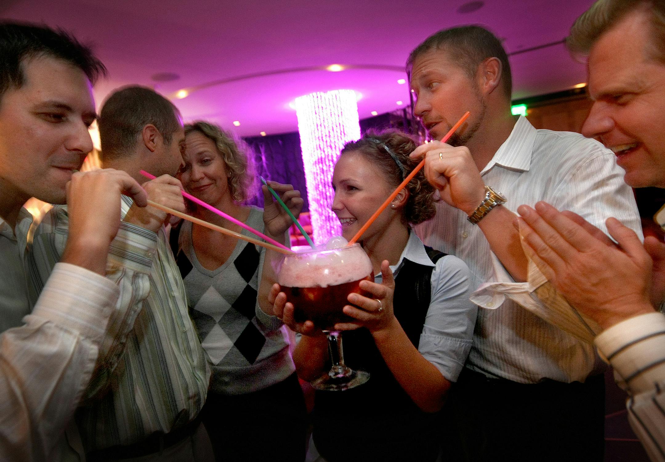 A group of friends drink from the Bubbling Sex Pot.