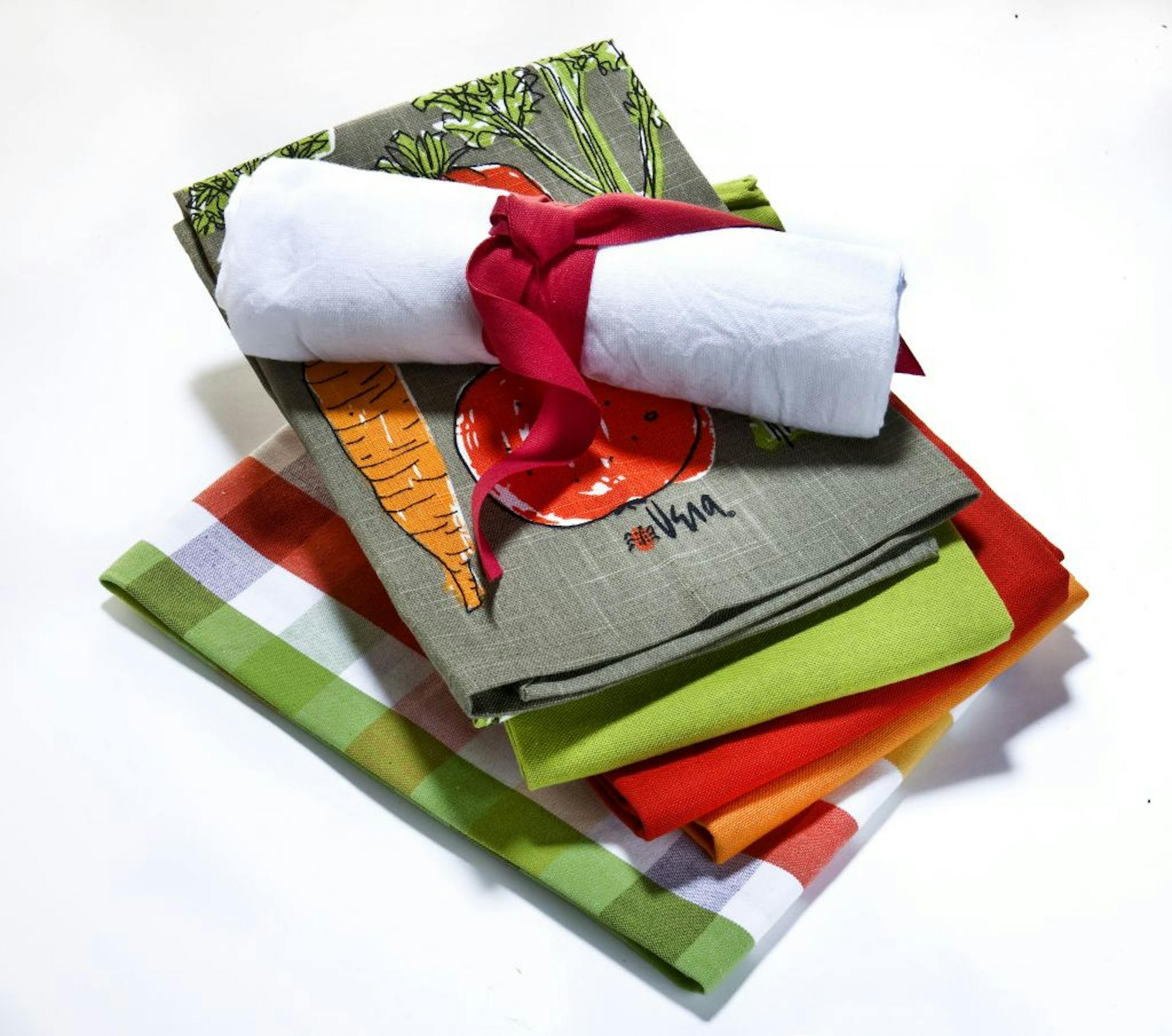It's time to reconsider the lowly kitchen towel. Rolled: Flour sack dishtowel; set of 3, $9.95. Folded towels, top to bottom: The Insalata dishtowel, designed by Vera Neumann, is one in a series of archival prints released to Crate and Barrel; $5.95. Set of 3 flour sack dishtowels (green, red and orange); $15.95. Fiesta plaid dishtowel; $4.95. All available at crateandbarrel.com.