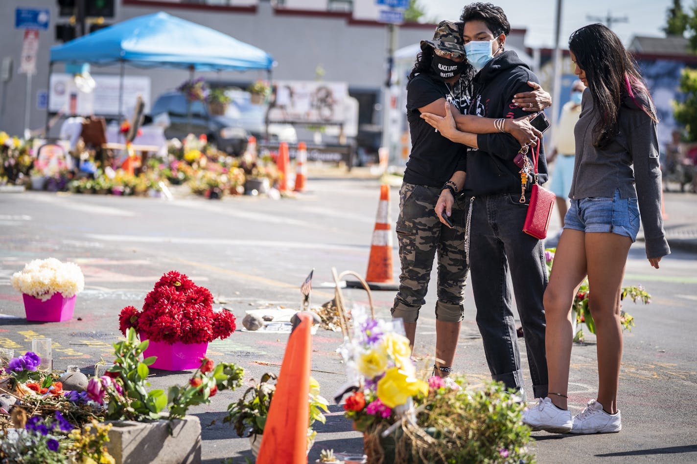 Constance Pearson-Howey, left, of St. Cloud, accompanied by her children Tai Pearson, 16, and Tia Pearson, 17, visited the George Floyd memorial outside Cup Foods, Thursday, June 25, 2020, in Minneapolis.