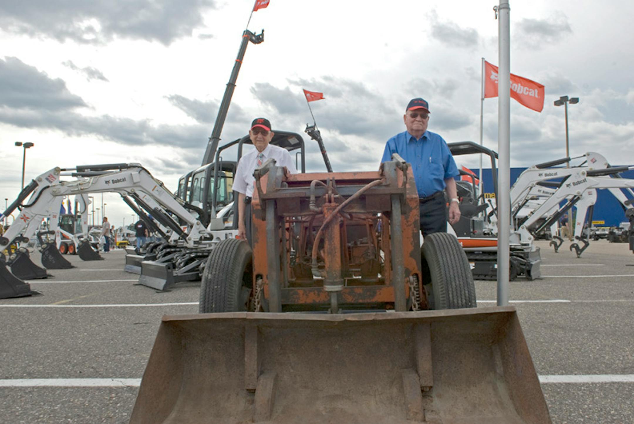 Cyril Keller, left, and brother Louis Keller stood by the seventh of seven original Keller Loaders.