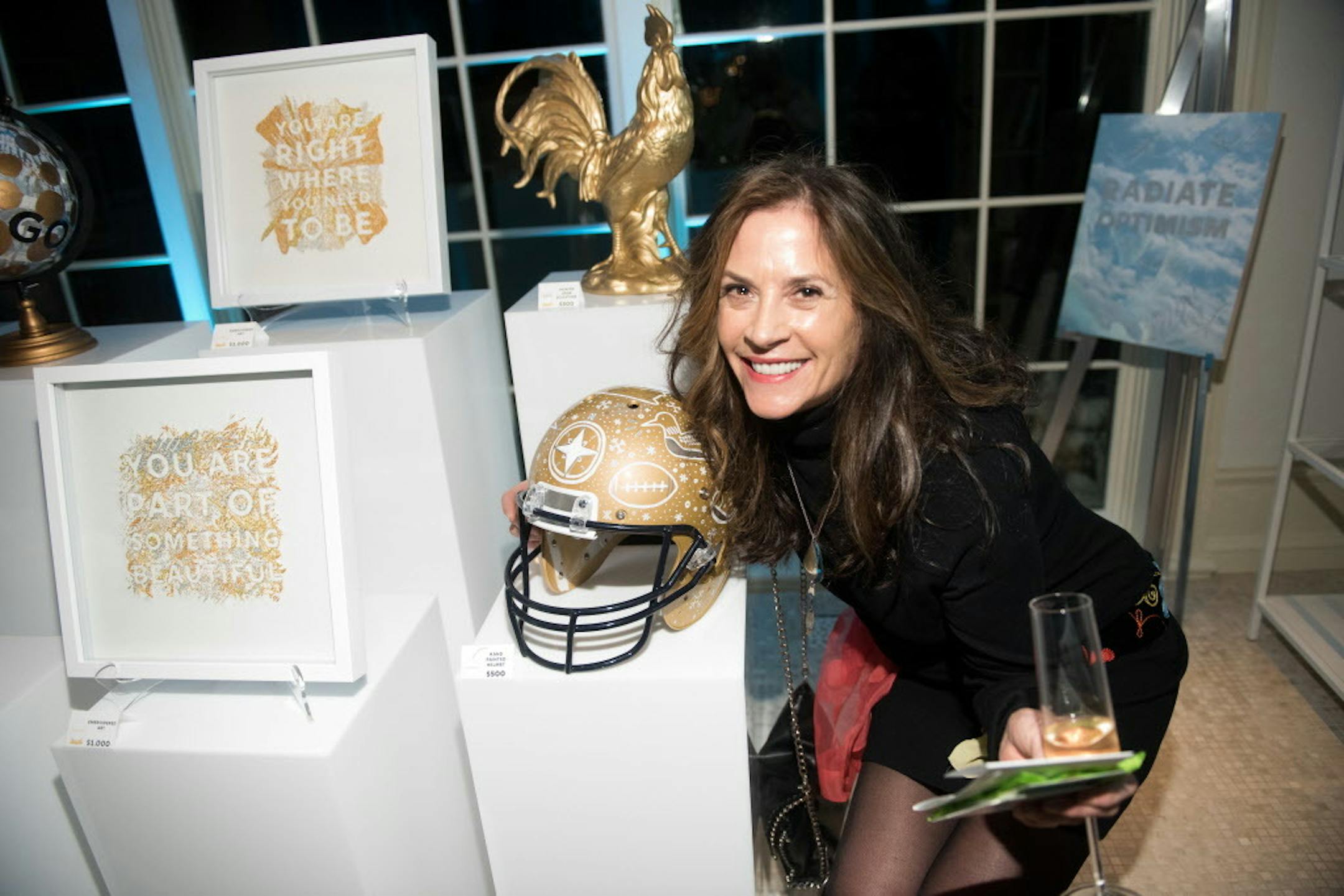 Party guest Mary Carroll posed for a photo near items up for auction.