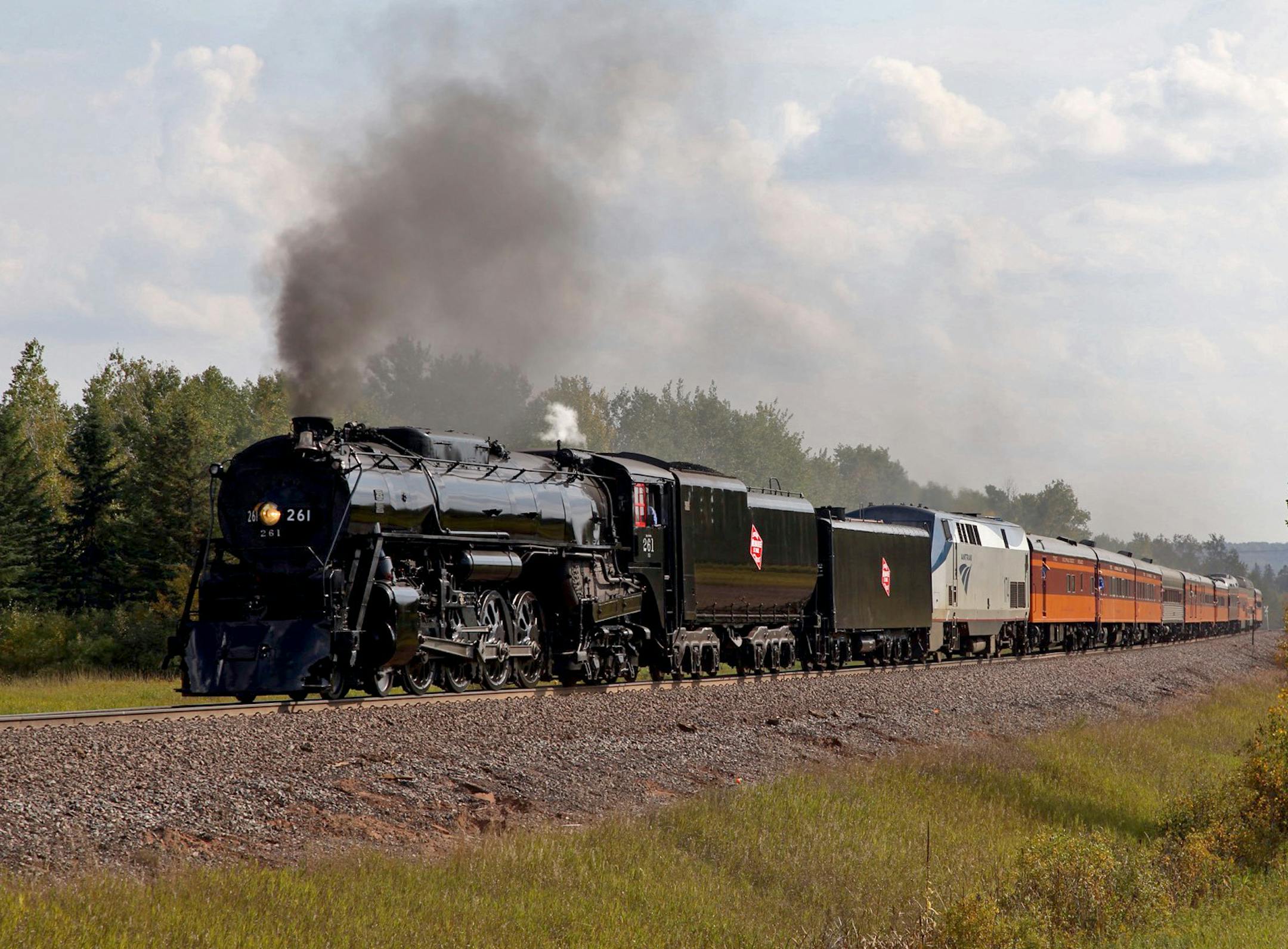 Courtesy of Jeff Terry. Caption: Milwaukee Road No. 261, a restored steam locomotive with a fleet of historic passenger cars, chugged to Duluth Saturday on a weekend excursion, one of several each year. It was a sentimental journey for many, including those grieving the loss of Judy Sandberg, who was instrumental in the nonprofit group called Friends of 261 Historic train makes trek honoring a woman who devoted many hours to its preservation. ORG XMIT: MIN1409271834500279
