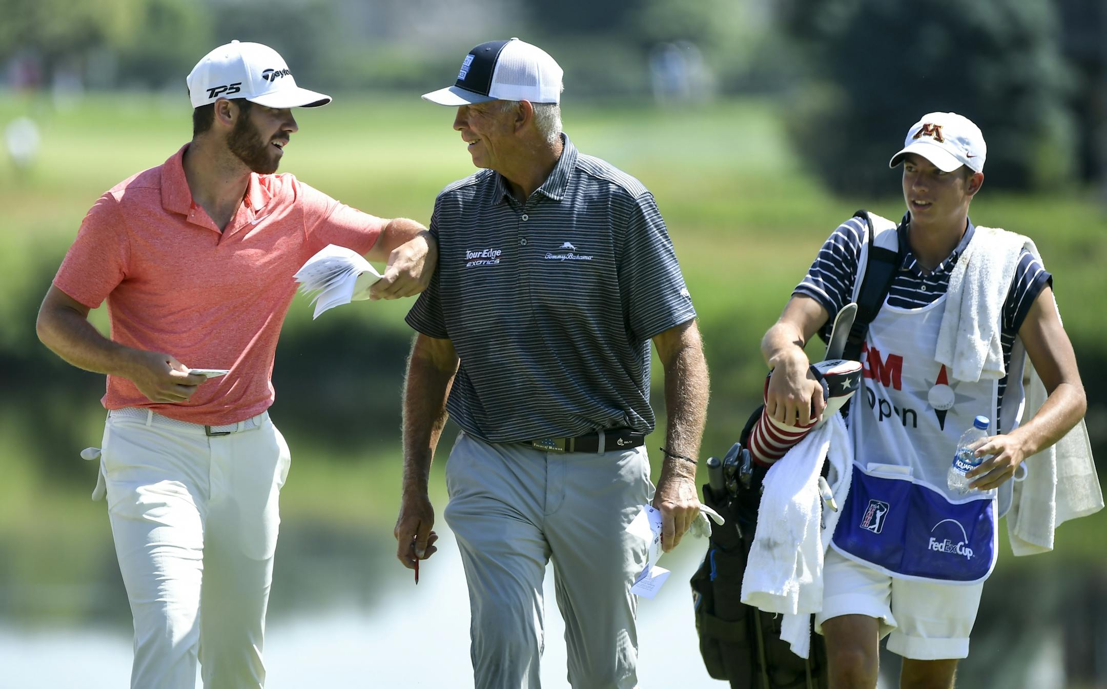 Matthew Wolff, left, joked with Tom Lehman as they walked to the 8th hole tee box following a birdie by Wolff and an eagle by Lehman on the 7th hole.