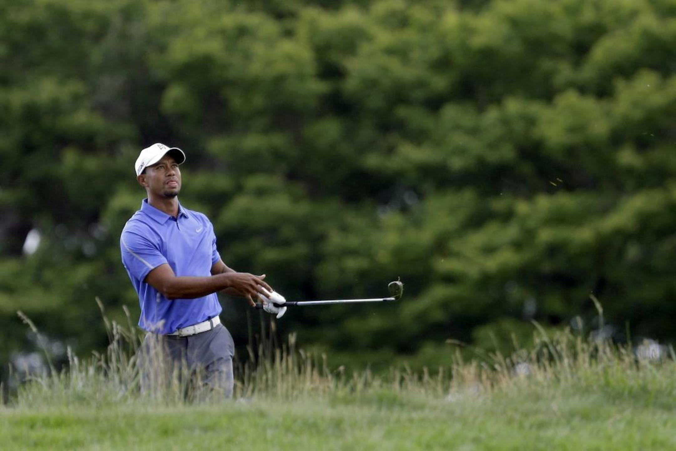 Tiger Woods watches his shot on the first hole during the first round of the U.S. Open golf tournament at Merion Golf Club, Thursday, June 13, 2013, in Ardmore, Pa.