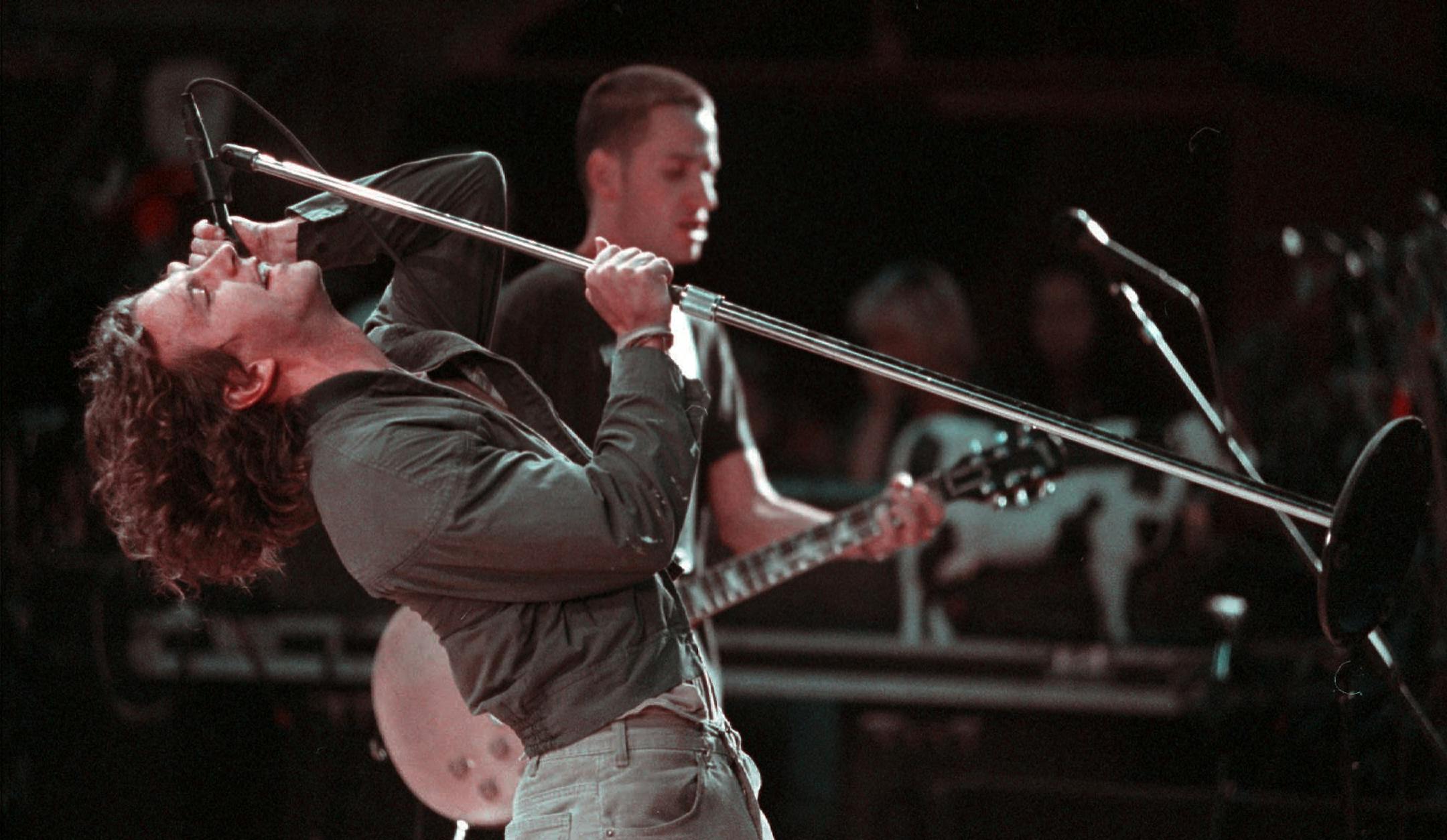 FILE--Pearl Jam lead singer Eddie Vedder lifts a microphone stand during the band's performance June 19, 1995, in Morrison, Colo., near Denver. The concerts are back on, at least at Milwaukee's Summerfest lakeside music festival, organizers said Tuesday, June 27, 1995. Summerfest Director Elizabeth Bo Black said the popular grunge rock band will play as scheduled July 8-9 despite announcements that the group had canceled the remainder of its summer tour in a dispute with Ticketmaster over handli