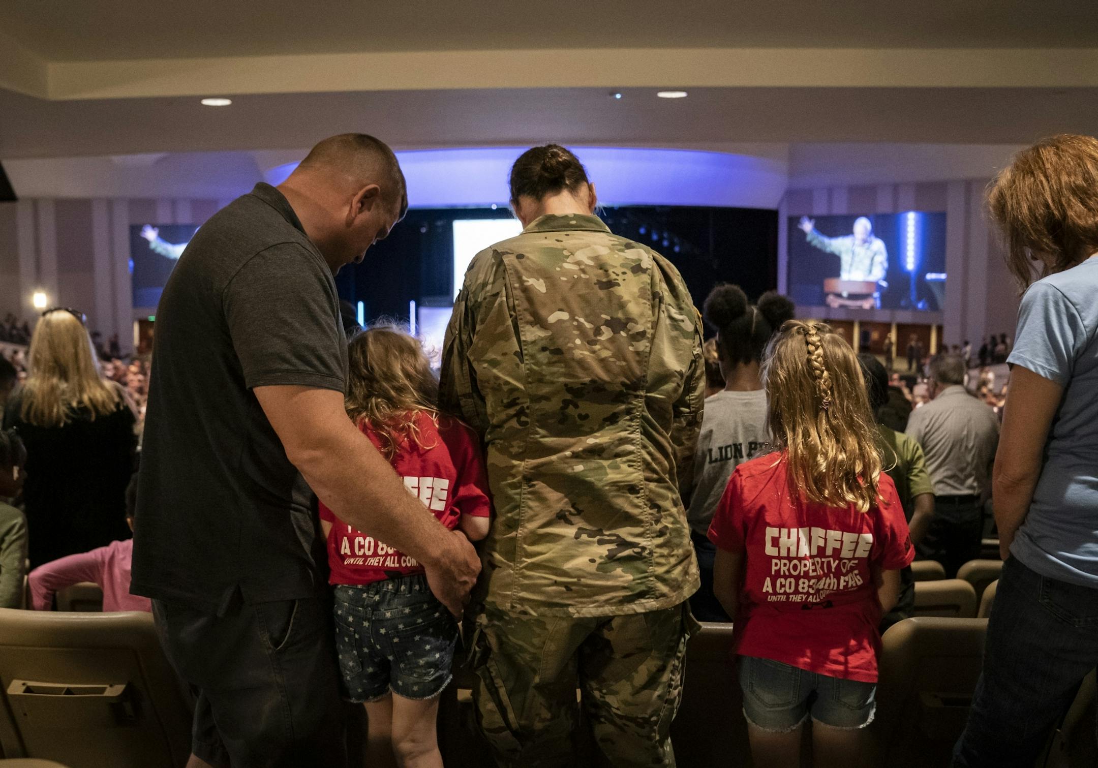 From the left; Brian, Ally, Jeanette and Madison, prayed with the Army chaplain during the family deployment ceremony in Eden Prairie, Minn., on Friday, September 20, 2019.