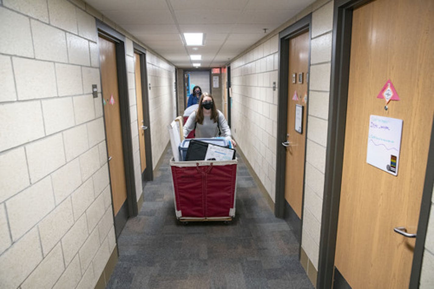 Riley Krenz, an freshman Chemistry major from Rosemount, MN, pushed a basket full of her belongings through Ianni Hall on Thursday as she moved into her room at UMD. ] ALEX KORMANN • alex.kormann@startribune.com The University of Minnesota Duluth spread out it's normally one day move-in bonanza over three days. Each student was given a specific move-in time to try and stagger the amount of people in the residence halls.