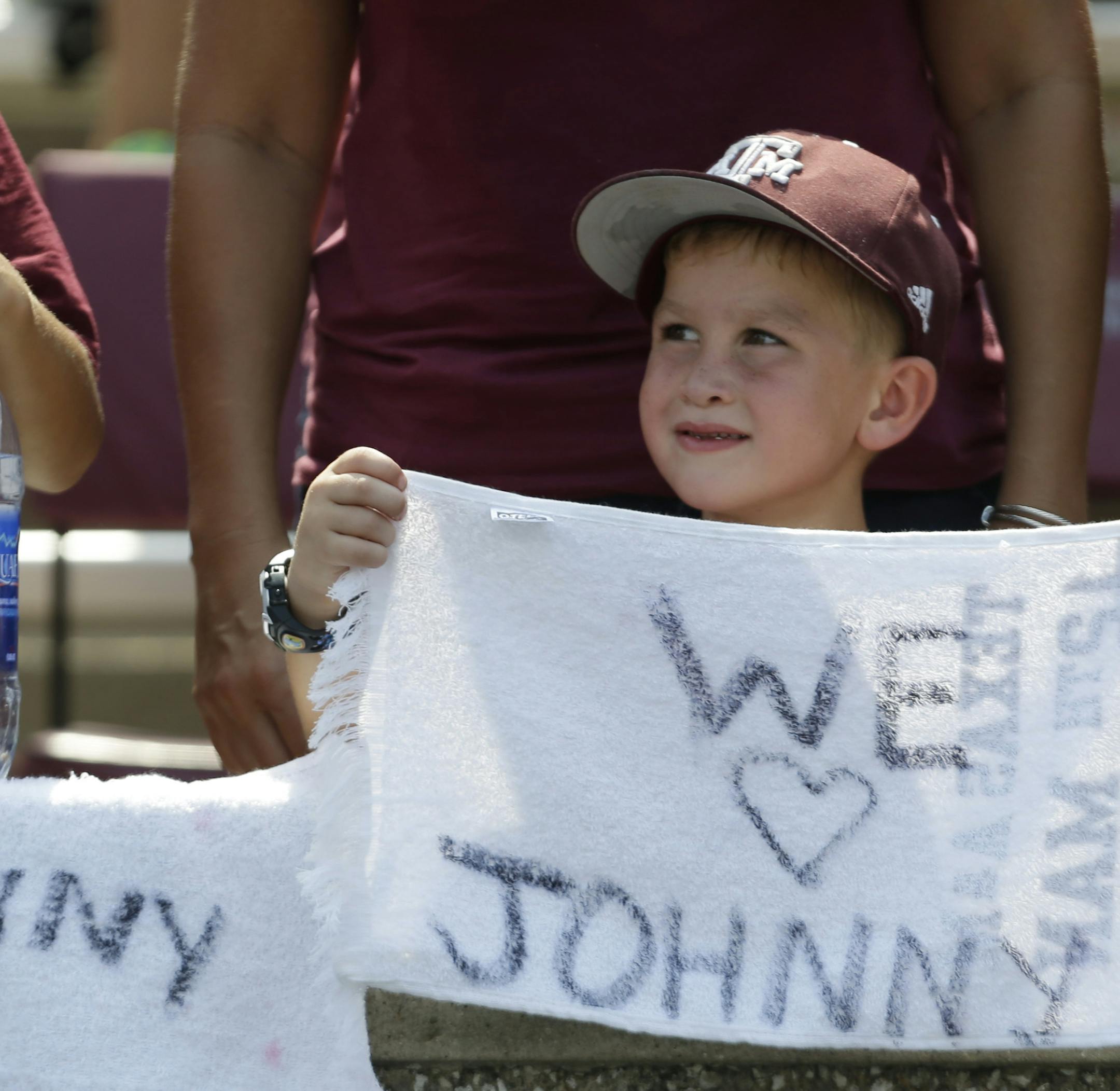 A fan holds a sign for Texas A&M quarterback Johnny Manziel during the fourth quarter of an NCAA college football game against Rice, Saturday, Aug. 31, 2013, in College Station, Texas. Manziel missed the first half due to an NCAA suspension. (AP Photo/Eric Gay) ORG XMIT: NYOTK