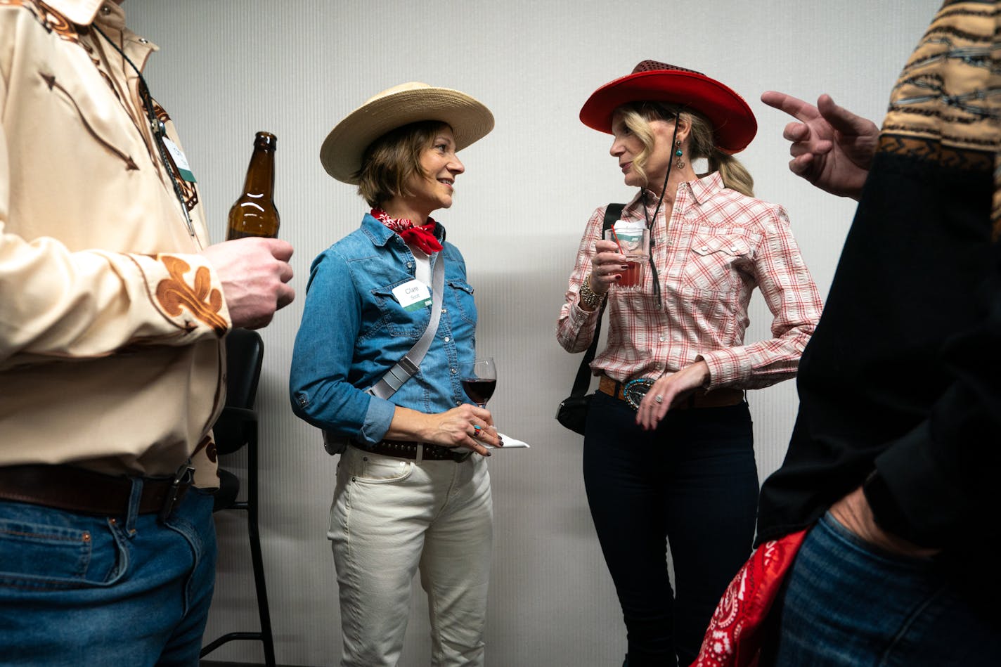 Clare Scott and Lisa Kro chat at the Ryan Companies' western-themed holiday party in Brooklyn Center, Minn. on Friday, Dec. 1, 2023. In a post-pandemic rise of the company holiday party, over 800 guests were invited to eat, drink and dance the night away. ] Angelina Katsanis • angelina.katsanis@startribune.com