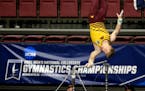 Minnesota's Shane Wiskus competes on the high bar during the NCAA men's gymnastics championships Saturday