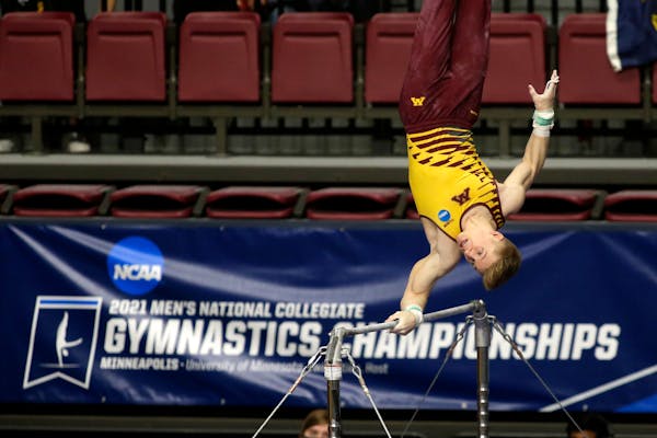 Minnesota's Shane Wiskus competes on the high bar during the NCAA men's gymnastics championships Saturday