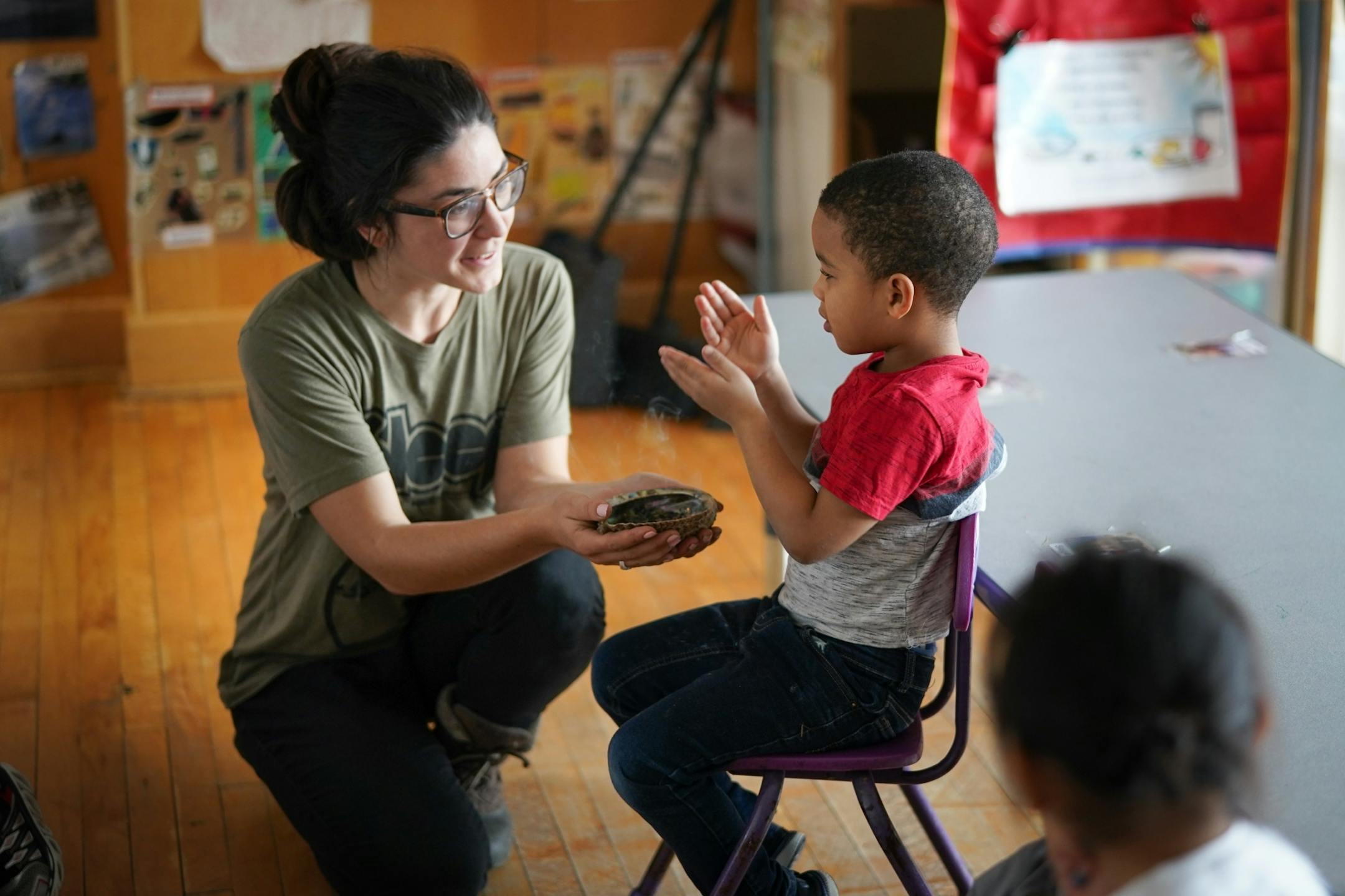 Ojibwe teacher Liz Zoongwegiizhigook Zinsli smudges with students each day. It helps them clear their mind, calm themselves down and prepare for learning. The Ojibwe immersion class is for students from 18 months to 5 years old, at Four Directions school.