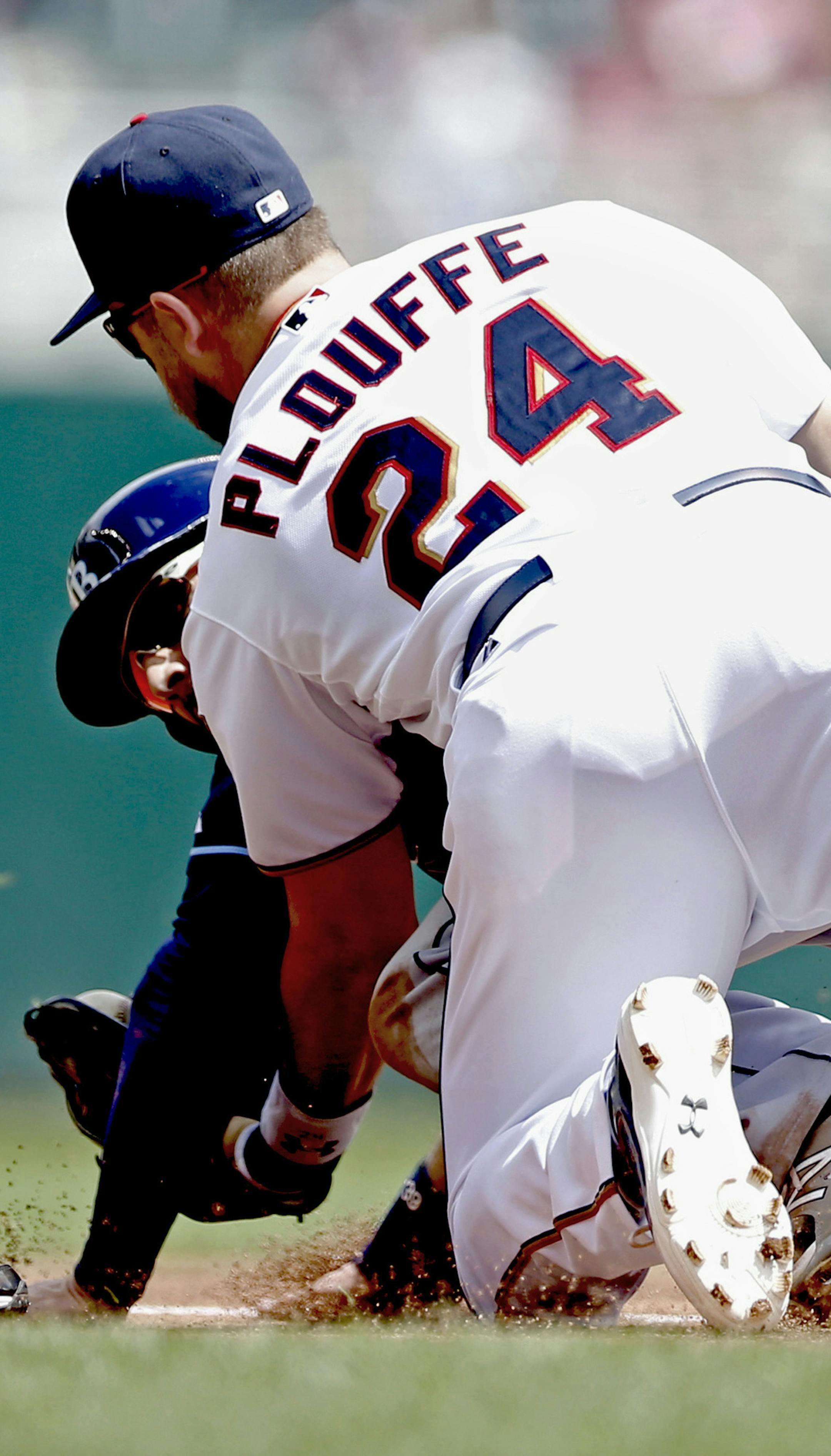 Minnesota Twins third basemanTrevor Plouffe, right, tags out Tampa Bay Rays’ Kevin Kiermaier as he attempted to advance to third base on a fielders choice in the first inning of a baseball game, Sunday, May 17, 2015, in Minneapolis. (AP Photo/Jim Mone)