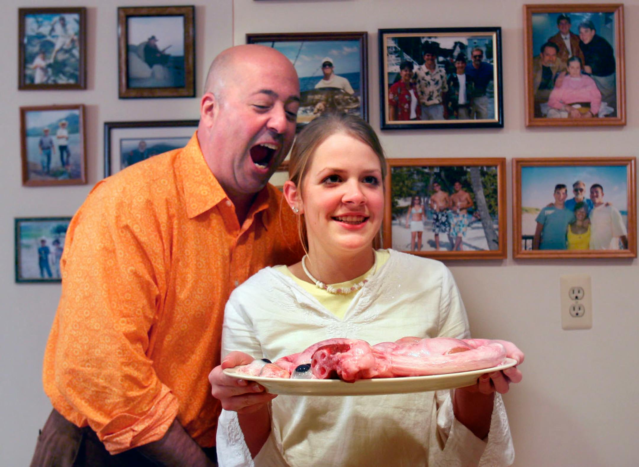 Andrew Zimmern jokes around with Annie Steward as Steward poses for her mother Colleen Needles Steward with a plate of cow's eyes and a bull's penis and testicles during an afternoon of filming on Gene Rurka's farm in New Jersey for Zimmern's new Travel Channel show Bizarre Foods. Colleen is the president of Tremendous Entertainment, the production company for Zimmern's show