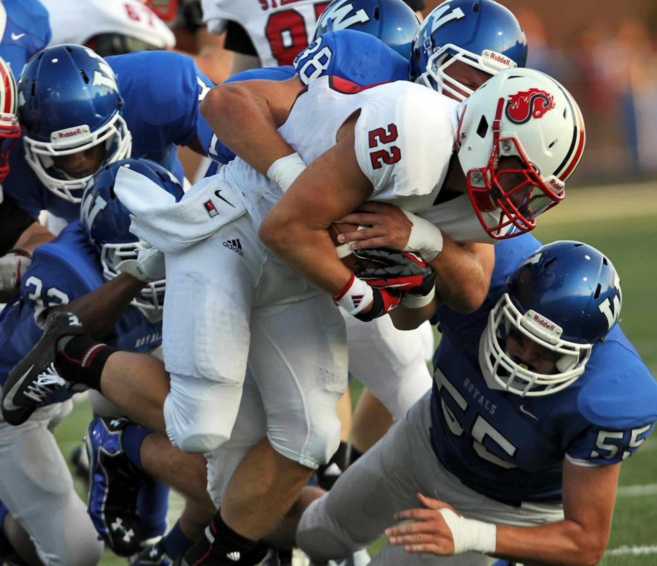 Stillwater vs. Woodbury prep football. The Woodbury defense threw Stillater running back Nick Anderson (22) for a loss. (MARLIN LEVISON/STARTRIBUNE(mlevison@startribune.com