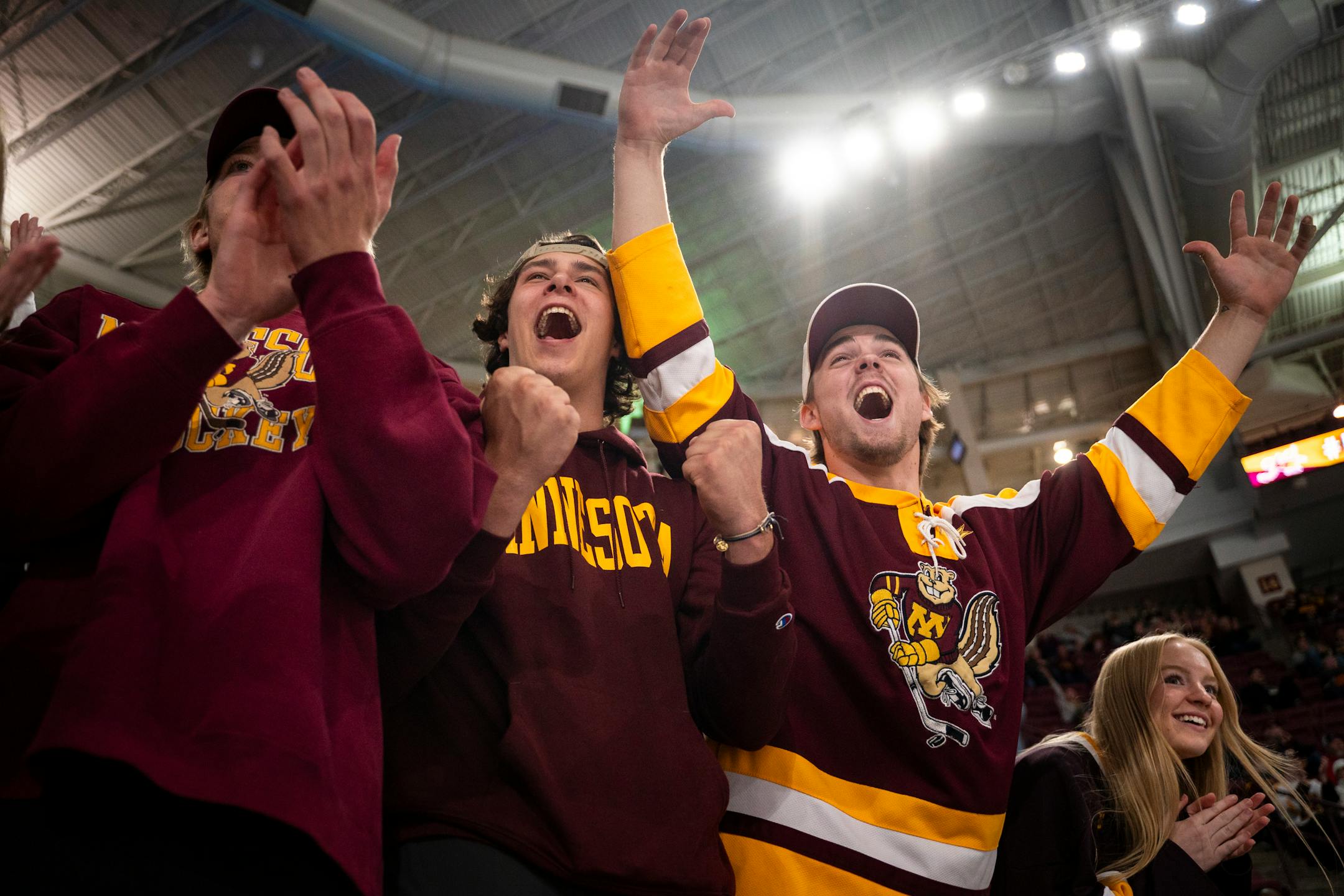 (from left) Henry Ramstorf, Lars Brotzman and Liam Sebek cheer for their school's final goal, setting the score to 5-2 against Bemidji State University.