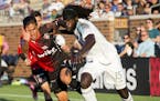 Minnesota United's Ismaila Jome, right, and Atlas' Jose Maduena vie for the ball during the first half ofan international friendly soccer match Saturd