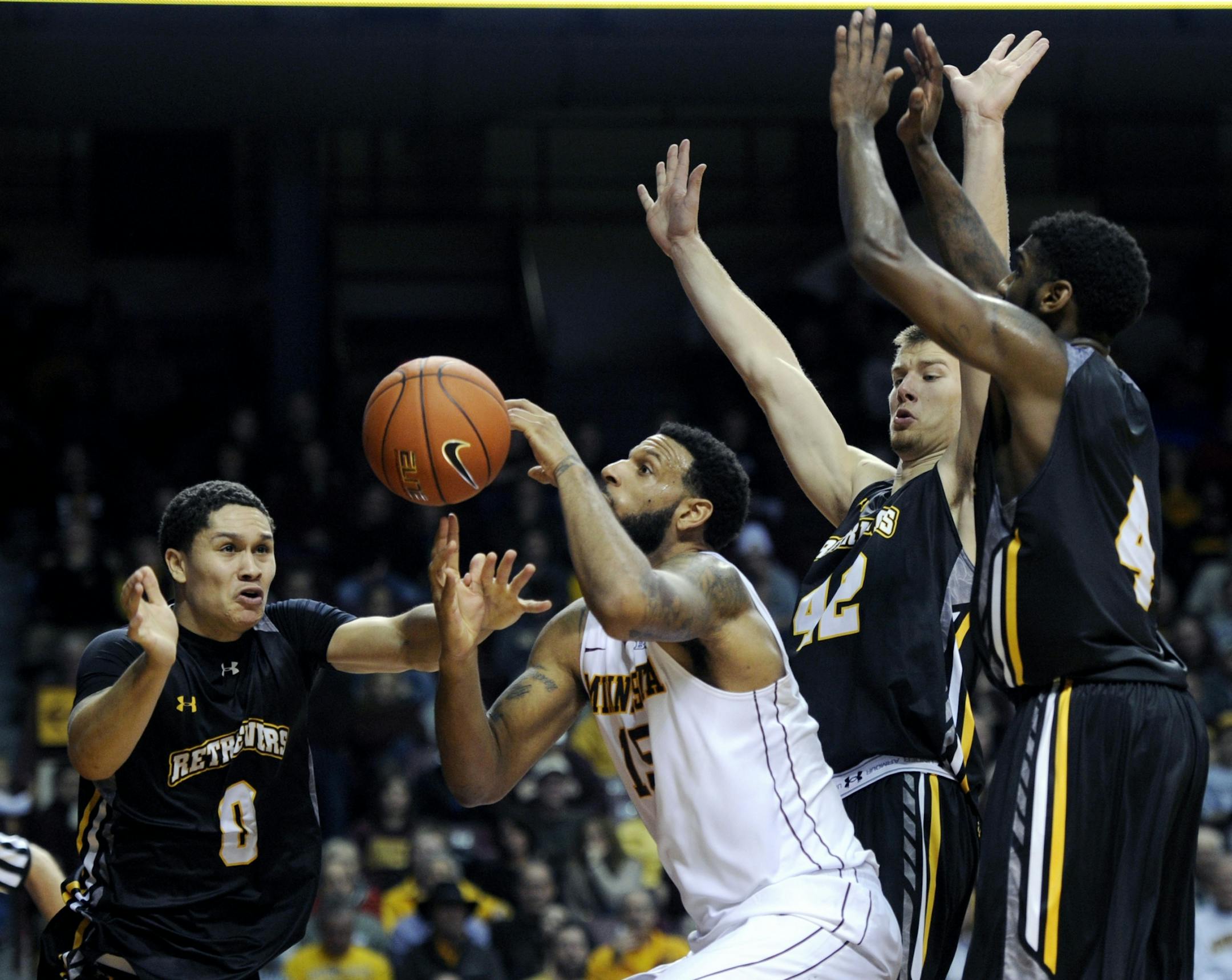 Maryland-Baltimore County guard Aaron Morgan (0) fouls Minnesota forward Maurice Walker (15) as Maryland-Baltimore County forward Cody Joyce (42) and Maryland-Baltimore County guard Wayne Sparrow (4) defend during the second half of an NCAA college basketball game Saturday, Nov. 22, 2014, in Minneapolis. Minnesota won 69-51.