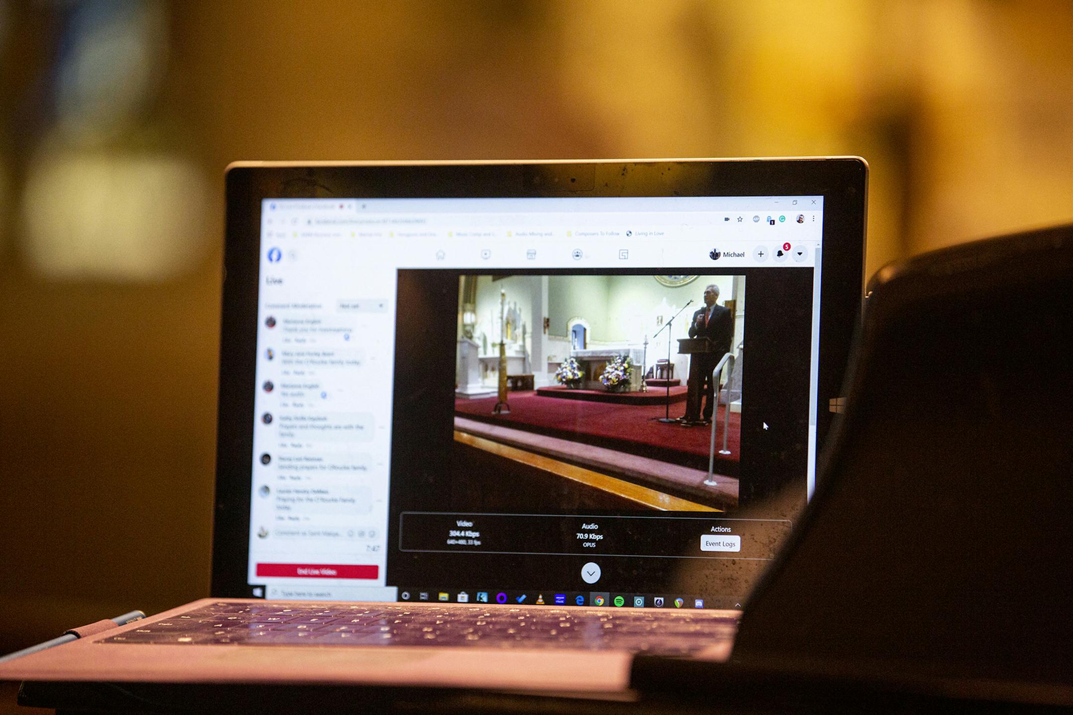 A Facebook live stream records the funeral at St. Margaret Church for families and friends unable to make it due to the coronavirus outbreak on Thursday, March 19, 2020. John O'Rourke, 69, of Lower Merion, Pa., speaks in front family and friends about his mother, Helen Casey O'Rourke. "Mom had a beauty that was far greater than anyone of them because her beauty came from inside," John said. "No one ever encountered my mom, that she didn't have smile on her face, a twinkle in her eye, and a word