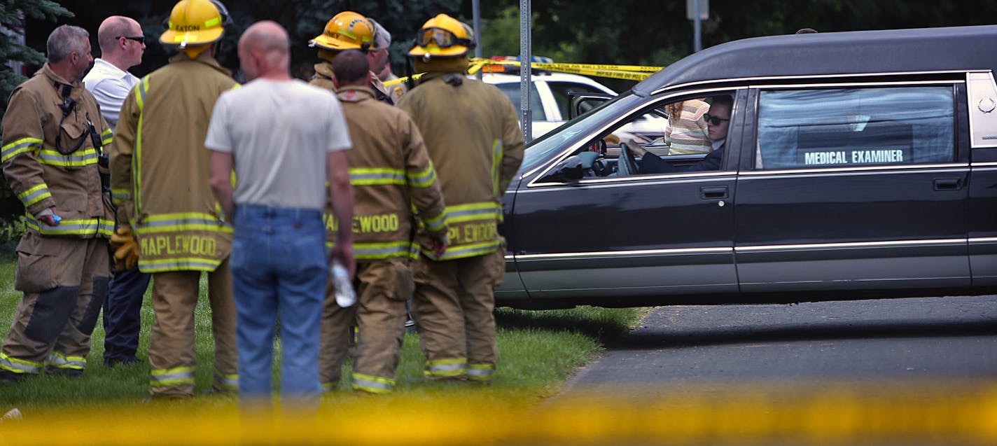 A vehicle from the medical examiner&#x201a;&#xc4;&#xf4;s office left the scene of a helicopter crash in Maplewood after picking up what appeared to be a body from the scene. ] (JIM GEHRZ/STAR TRIBUNE) / June 19, 2013, Maplewood, MN