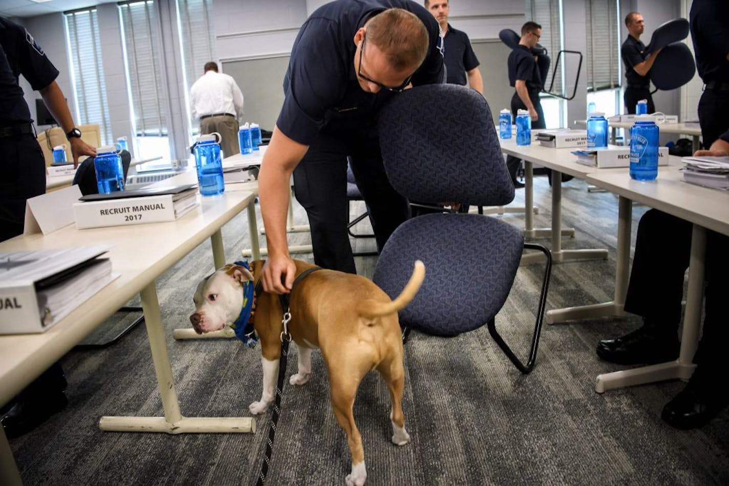 Minneapolis police recruits petted Wilbur at the end of class.