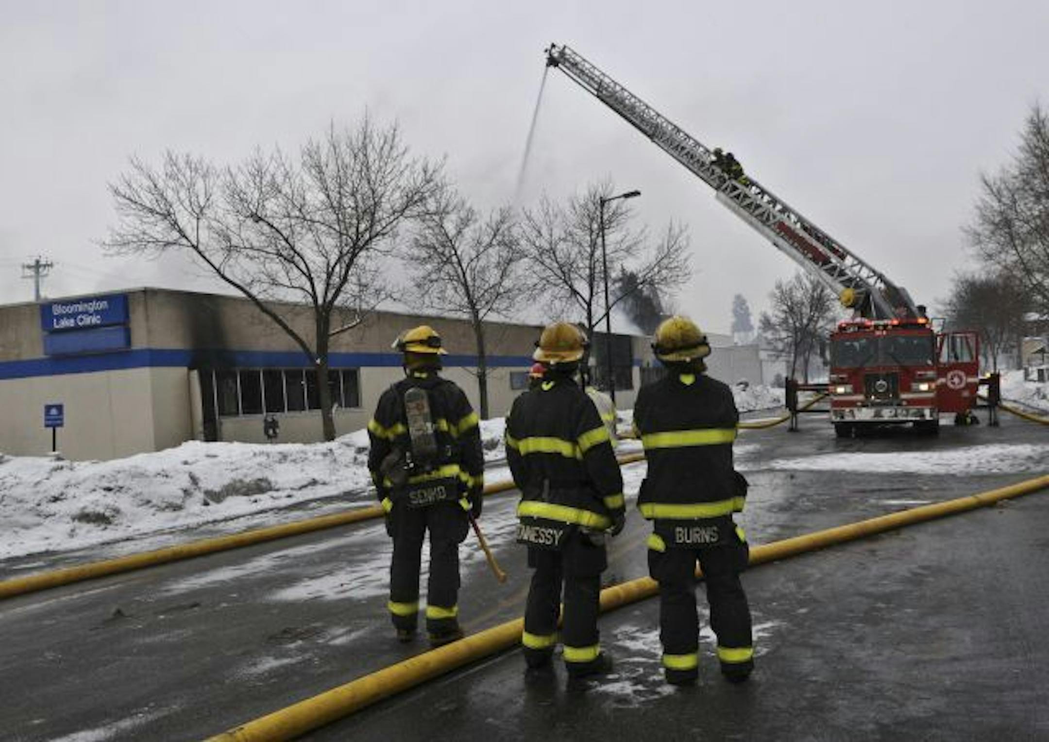 Firefighters used a ladder truck to spray water onto the roof of the Bloomington Lake Clinic.