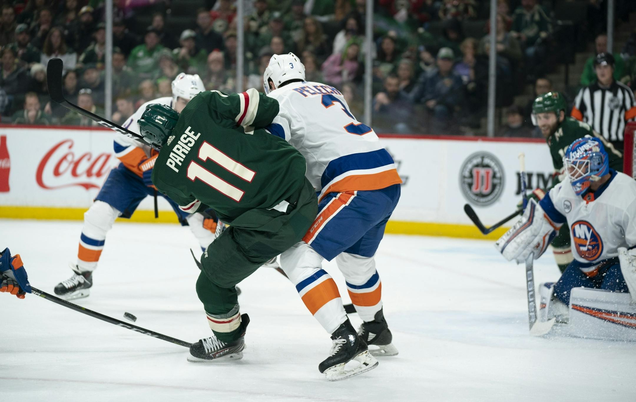 New York Islanders defenseman Adam Pelech (3) dropped Minnesota Wild left wing Zach Parise (11) in front of the net and was called for a hooking penalty in the first period.
