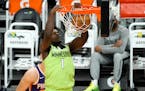 Minnesota Timberwolves forward Anthony Edwards (1) dunks against the Phoenix Suns during the first half of an NBA basketball game Thursday, March 18, 