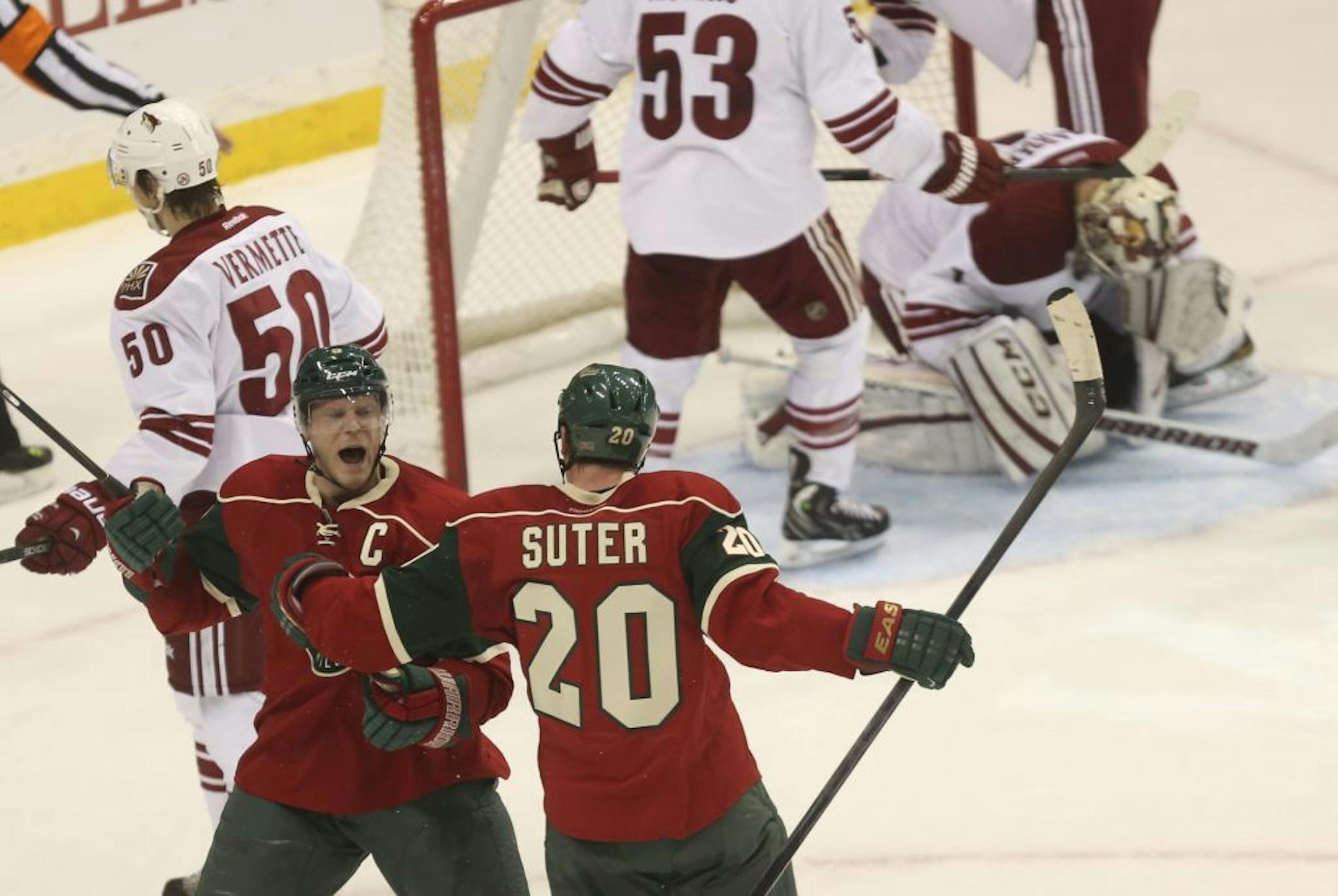 Mikko Koivu celebrated with teammate Ryan Suter after scoring the winning goal in overtime