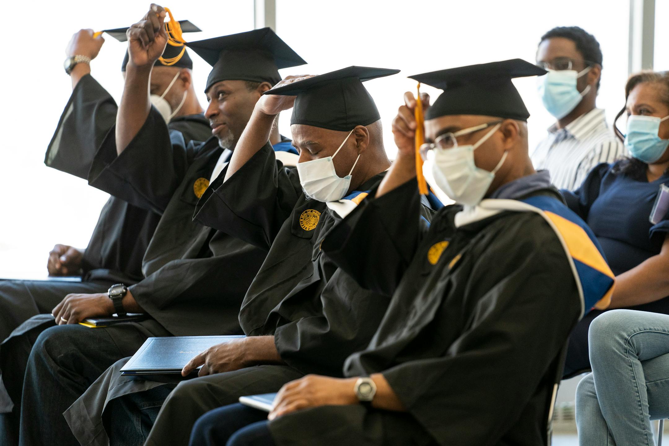 The graduates move their tassels during the commencement. MUST CREDIT: Washington Post photo by Carolyn Van Houten.