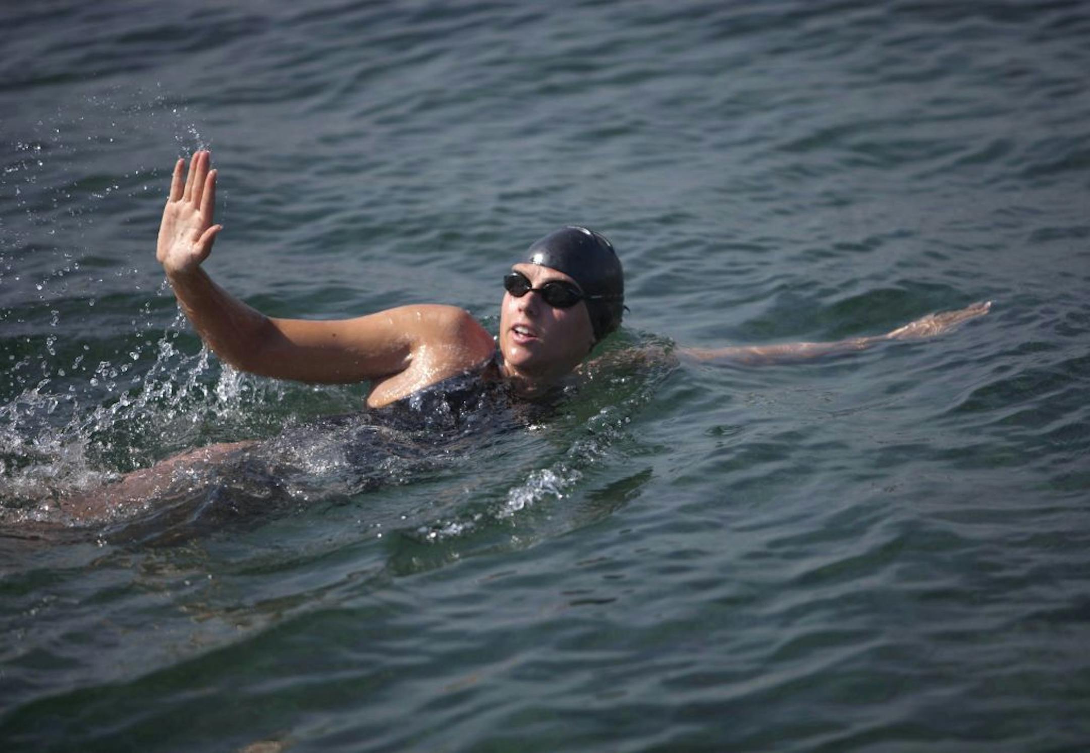 FILE - Australian swimmer Chloe McCardel waves to spectators as she begins her swim to Florida from the waters off Havana, Cuba, in a Wednesday, June 12, 2013 file photo.