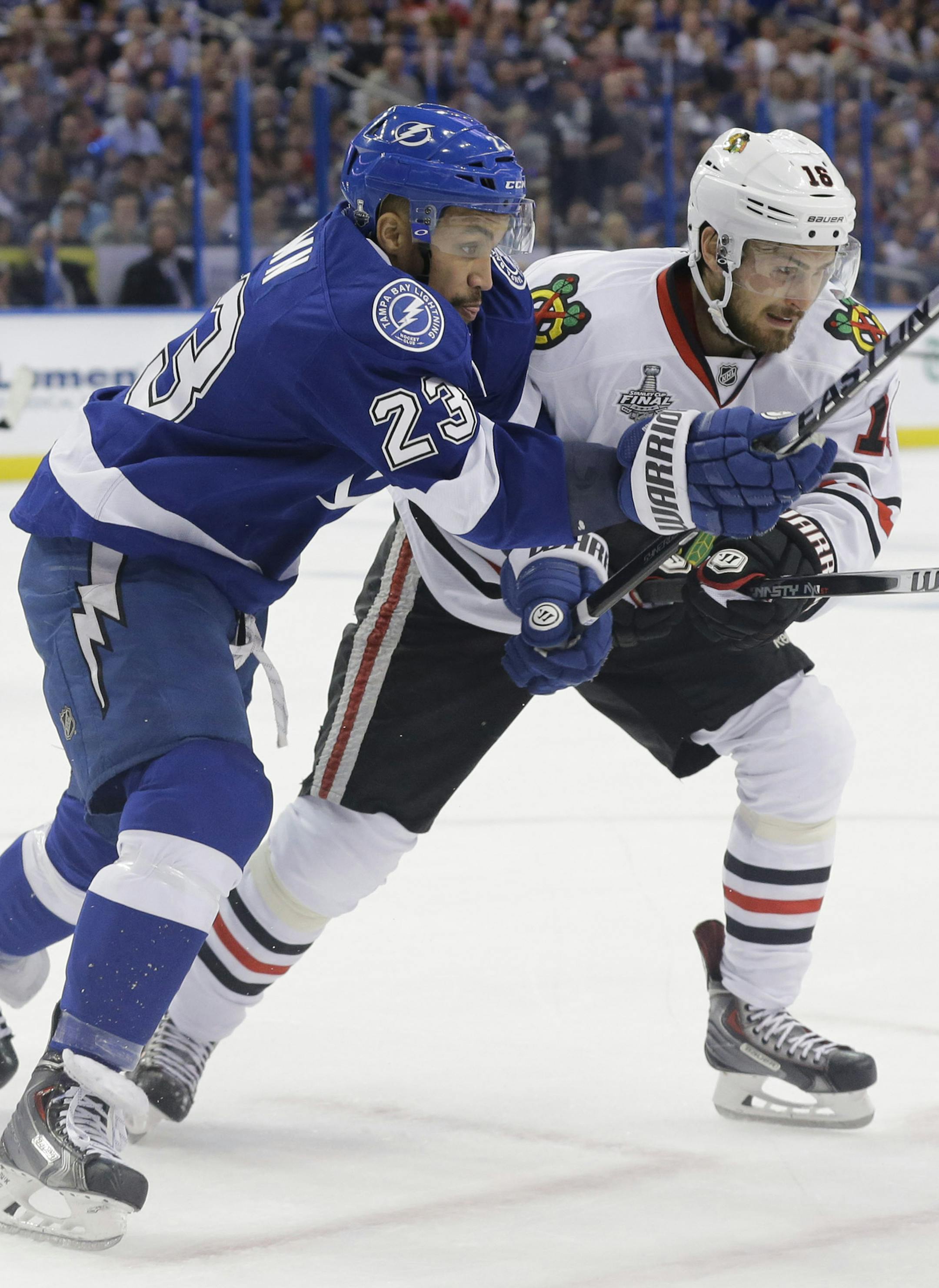 The Tampa Bay Lightning's J.T. Brown (23) tangles with the Chicago Blackhawks' Marcus Kruger in the first period in Game 1 of the Stanley Cup Final at Amalie Arena in Tampa, Fla., on Wednesday, June 3, 2015. (Dirk Shadd/Tampa Bay Times/TNS) ORG XMIT: 1169010
