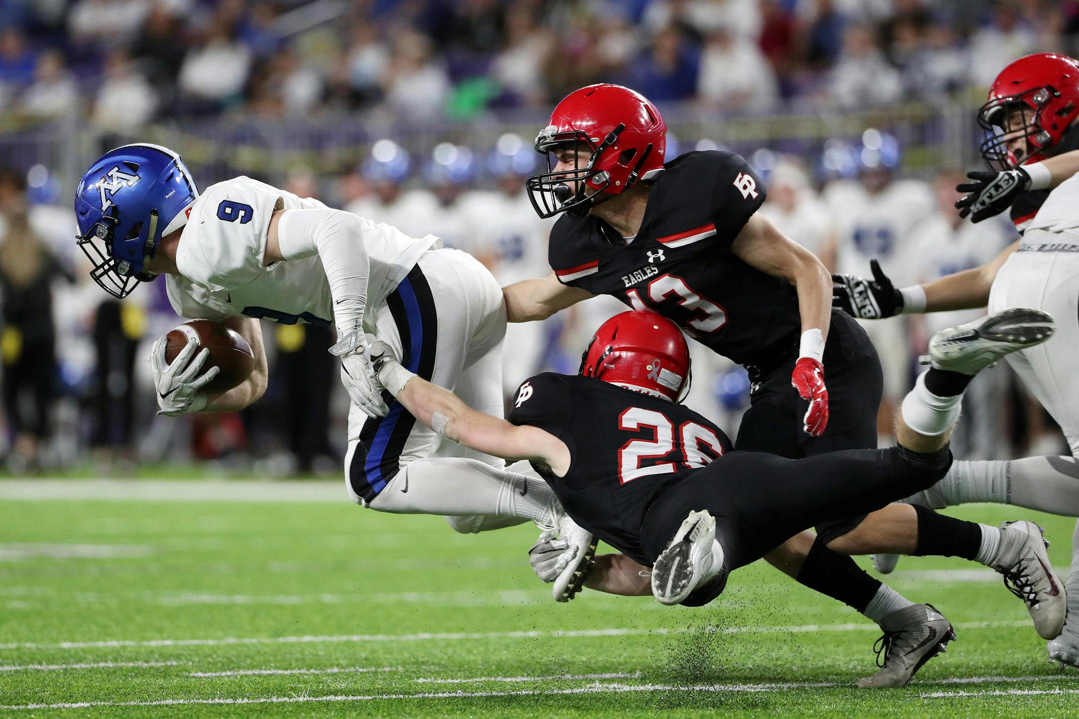 Eden Prairie defensive backs Grant Harstad (26) Aaron Timm (13) tried to stop Minnetonka's Jack Beil during the Class 6A Prep Bowl. (Anthony Souffle / Star Tribune)