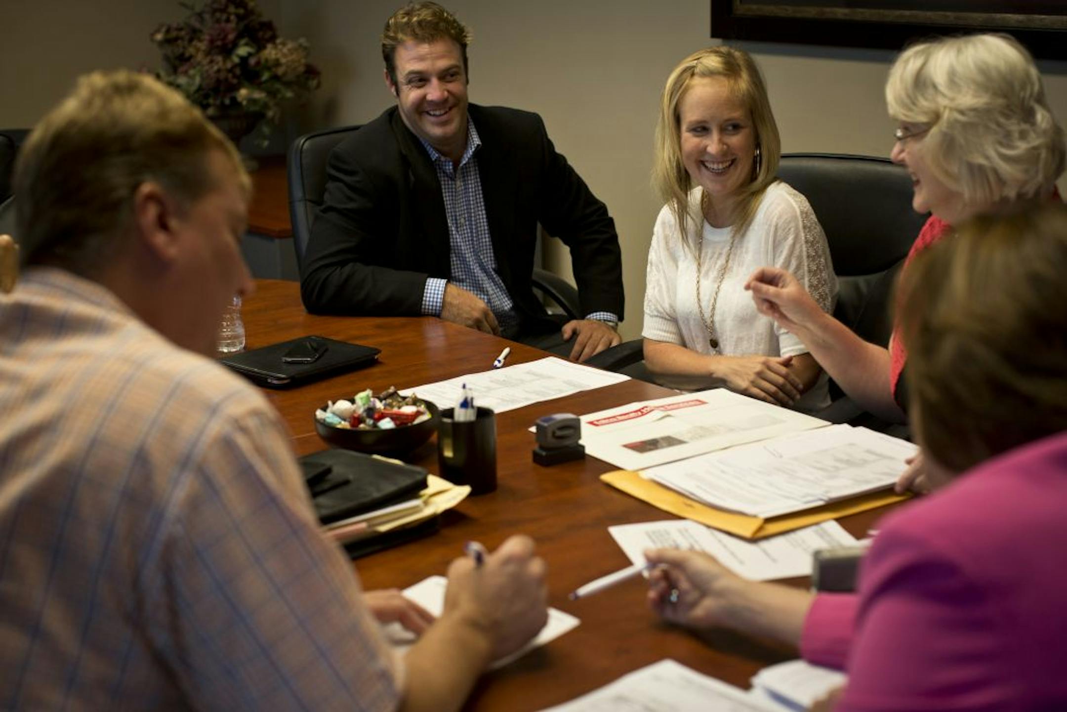 Homeowner Dana Johnson was all smiles as she finished the paperwork to sell her Minnetonka home with her Agent Judd Sampson and seller representative Mary Knoepfler (at right) on Friday, August 10, 2012 at Alliance Title in Edina, Minn. The buyers were not present at the closing. Johnson's home was on the market for one day before it sold.