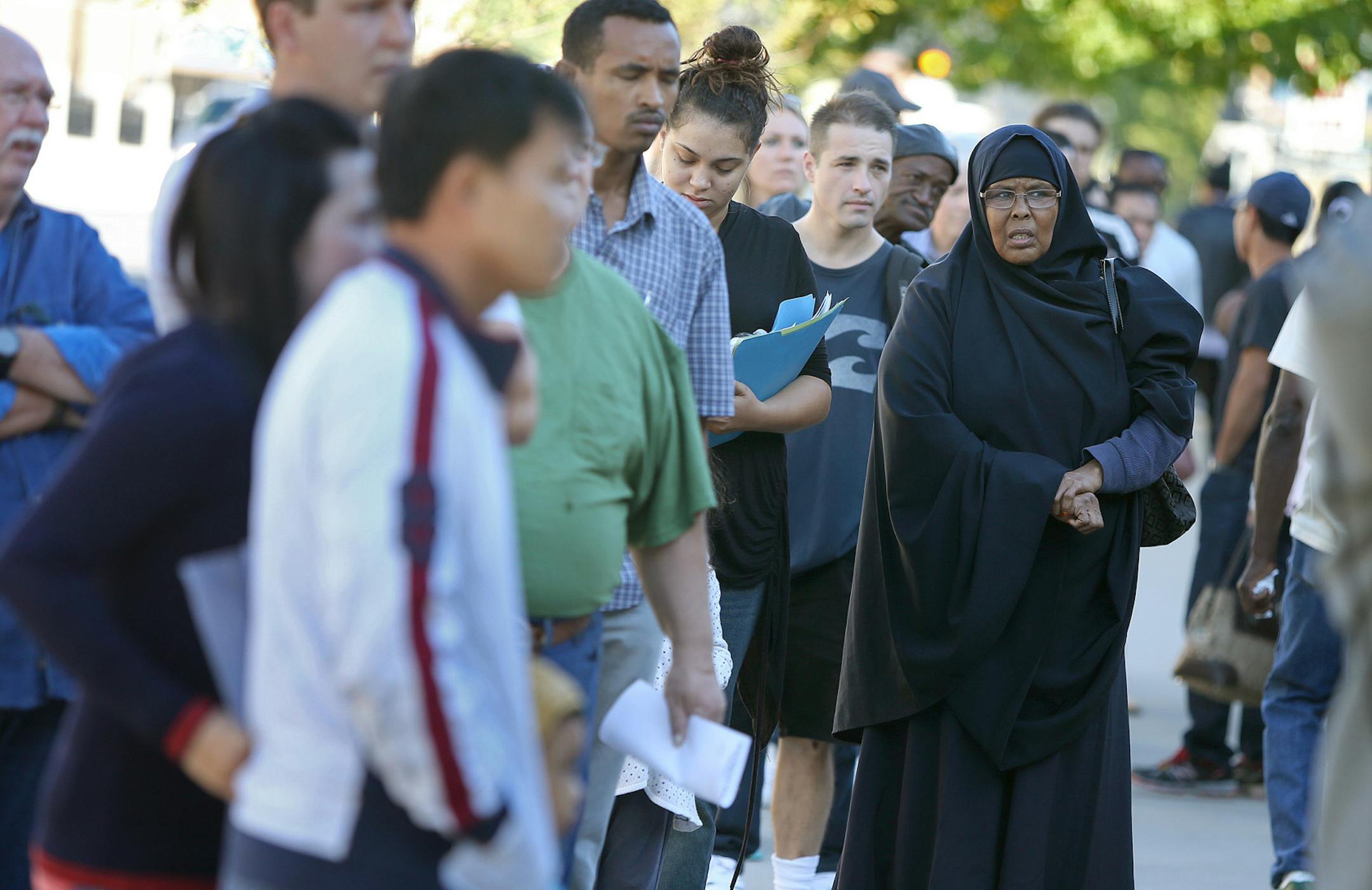 A crowd waiting outside the Social Security Administration Card Center building listened as they were turned away for certain services, Tuesday, October 1, 2013 in Minneapolis, MN. (ELIZABETH FLORES/STAR TRIBUNE) ELIZABETH FLORES • eflores@startribune.com