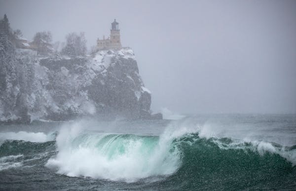 Massive waves crashed on the shoreline by the Split Rock Lighthouse in Two Harbors, MN as snow fell on Wednesday November 27. 2019. ]