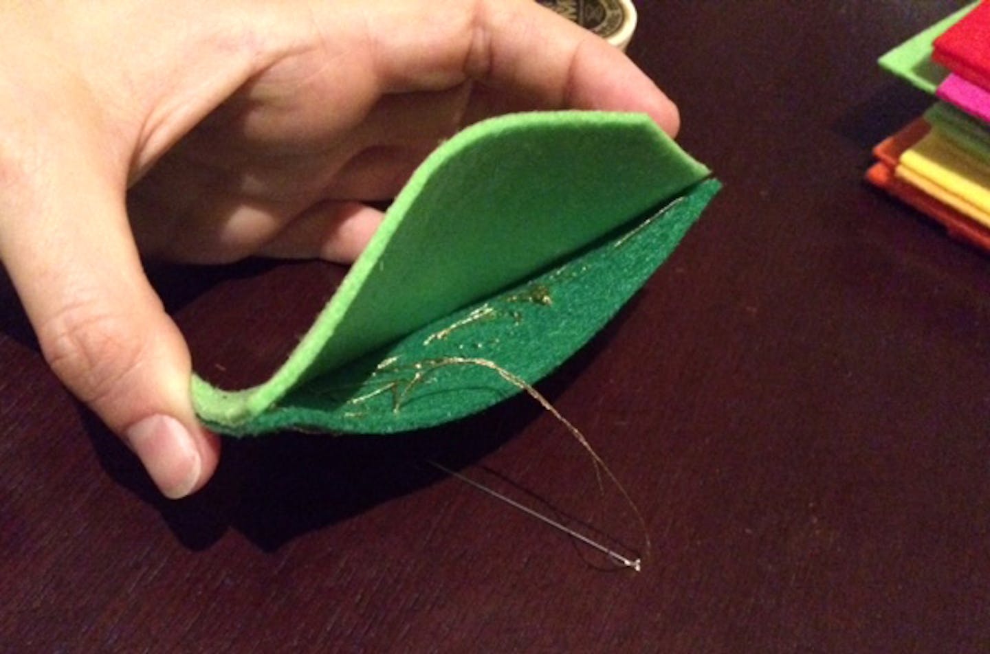 Part of step-by-step instructions for crafting a felt dumpster fire holiday ornament.