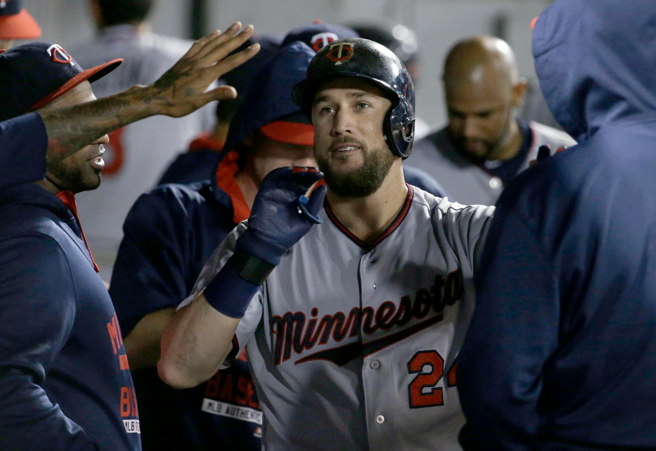 Minnesota Twins' Trevor Plouffe celebrates with teammates after hitting a solo home run against the Chicago White Sox during the eighth inning of a baseball game, Friday, Sept. 11, 2015, in Chicago. The Twins won 6-2. (AP Photo/Nam Y. Huh)
