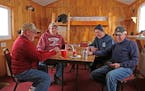 Rod Kraus, left, Jim Bannick, Dave Engh and Frank Ketchmark gather on the Mille Lacs ice about 3 p.m. every day to play cards, talk smart, drink a bee