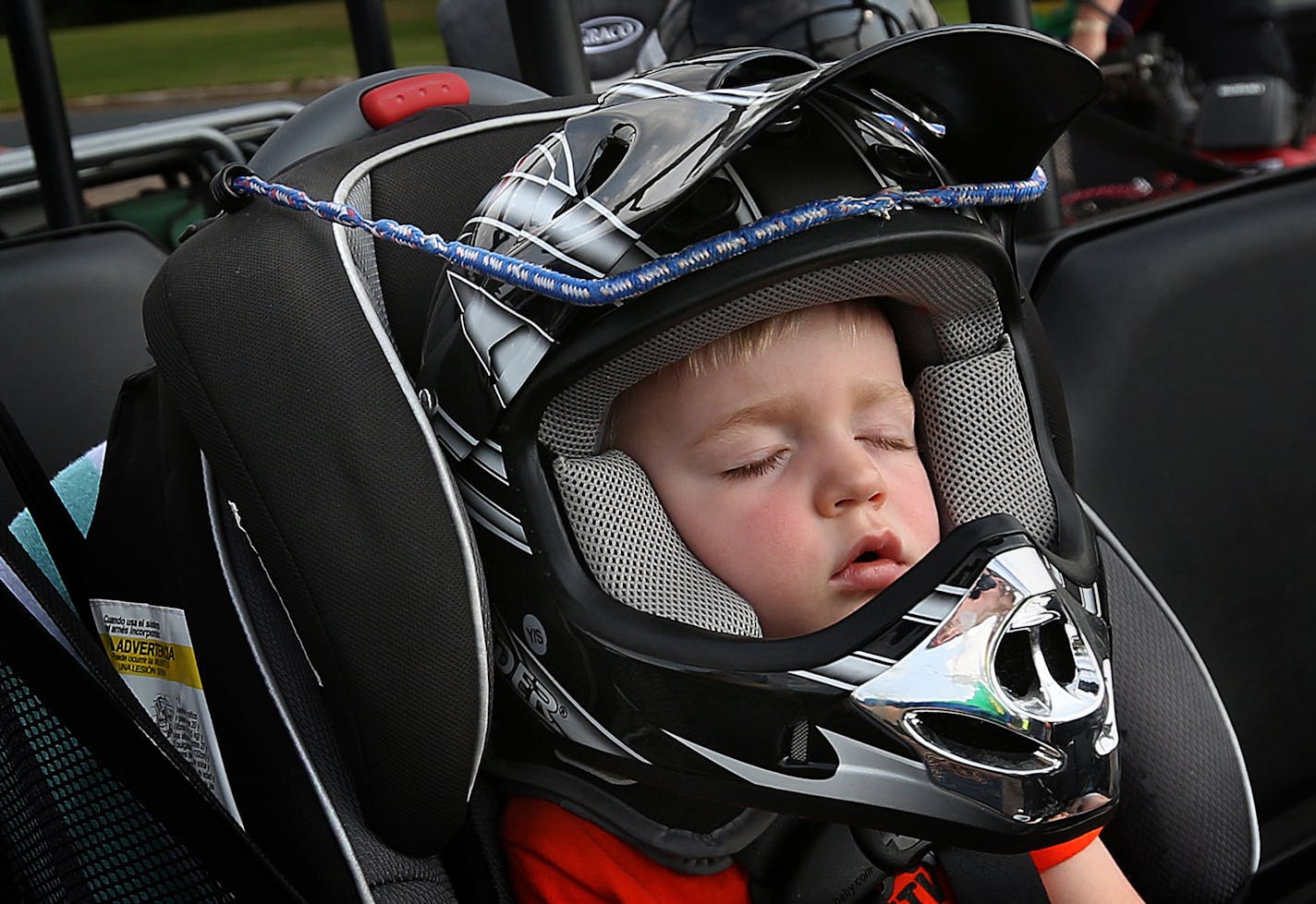 One-and-a-half-year-old Ryan Anderson fell asleep in the front seat of his grandparents&#x201a;&#xc4;&#xf4; ATV. A bungee cord was used to secure his head. ] JIM GEHRZ &#x201a;&#xc4;&#xa2; jgehrz@startribune.com / Luck, WI 7/31, 2014 / 7:00 PM / BACKGROUND INFORMATION: Ride-a-long with members of the Luck Area ATV Club, along the roads of Polk County, WI., where riding of the vehicles is allowed on some county roads. ORG XMIT: MIN1410011445520296