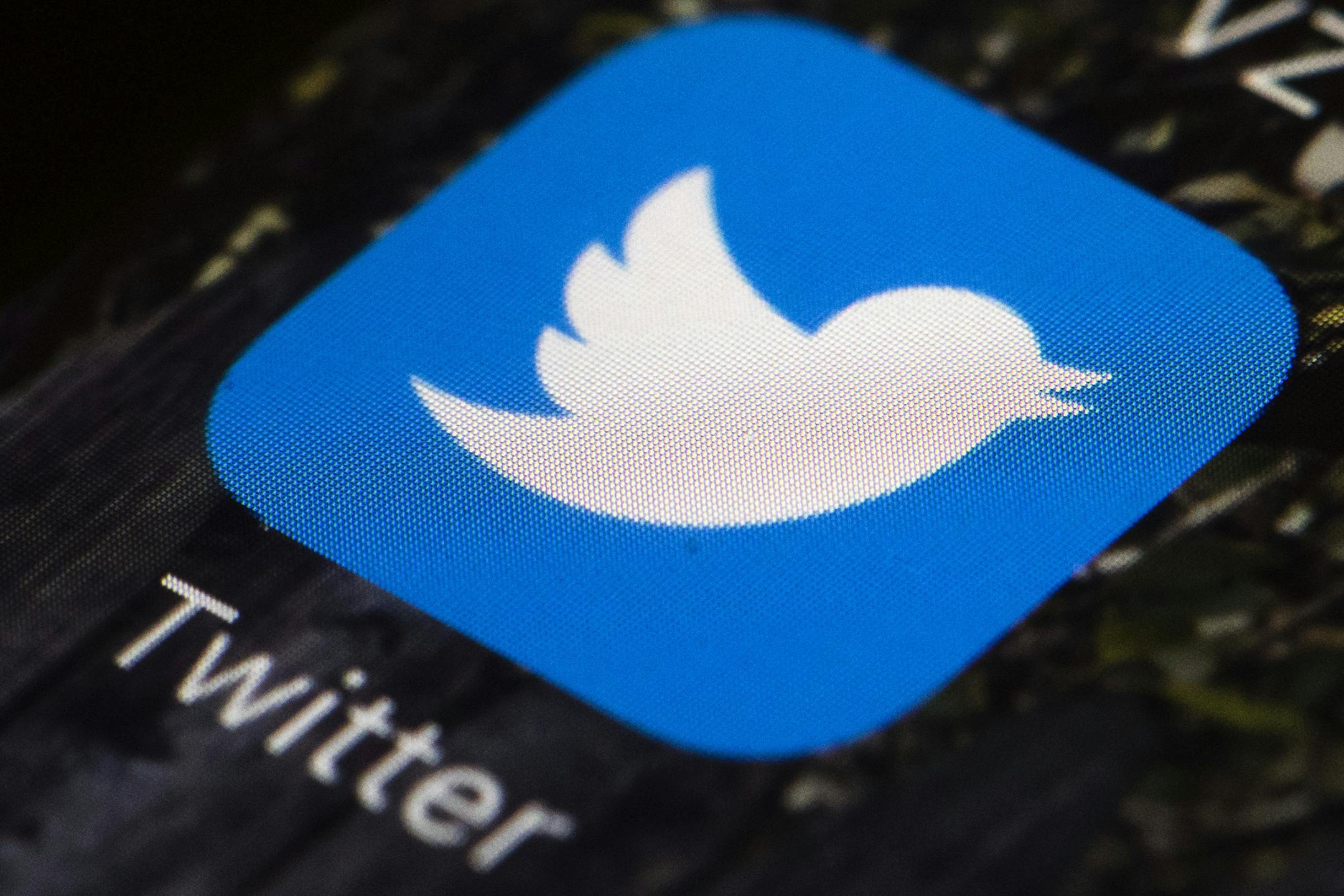 FILE- This April 26, 2017, file photo shows the Twitter icon on a mobile phone, in Philadelphia. Twitter reports earnings Thursday, Feb. 8, 2018. (AP Photo/Matt Rourke, File)