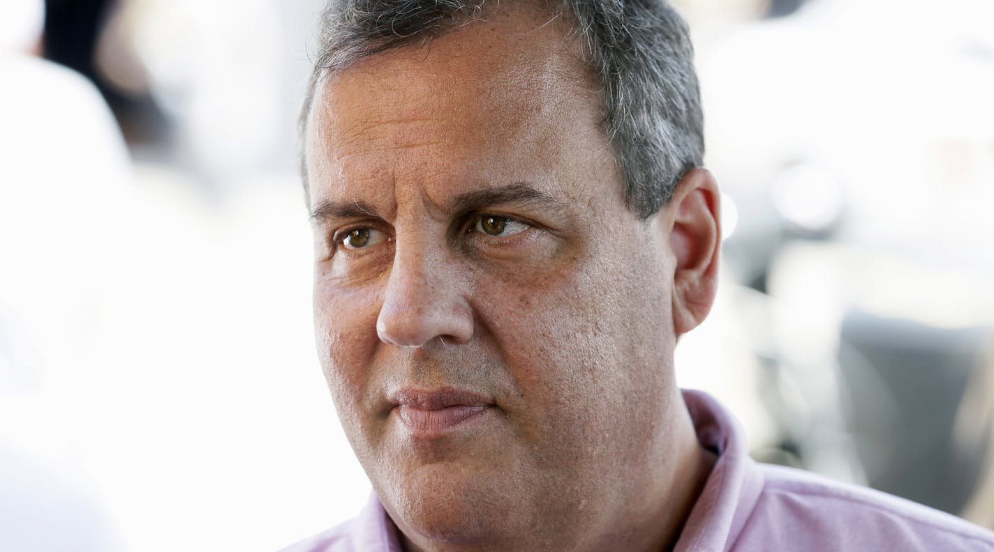 Republican presidential candidate, New Jersey Gov. Chris Christie talks with drivers in the garage area before the NASCAR Xfinity Series auto race, Saturday, Aug. 1, 2015, at Iowa Speedway in Newton, Iowa. (AP Photo/Charlie Neibergall)