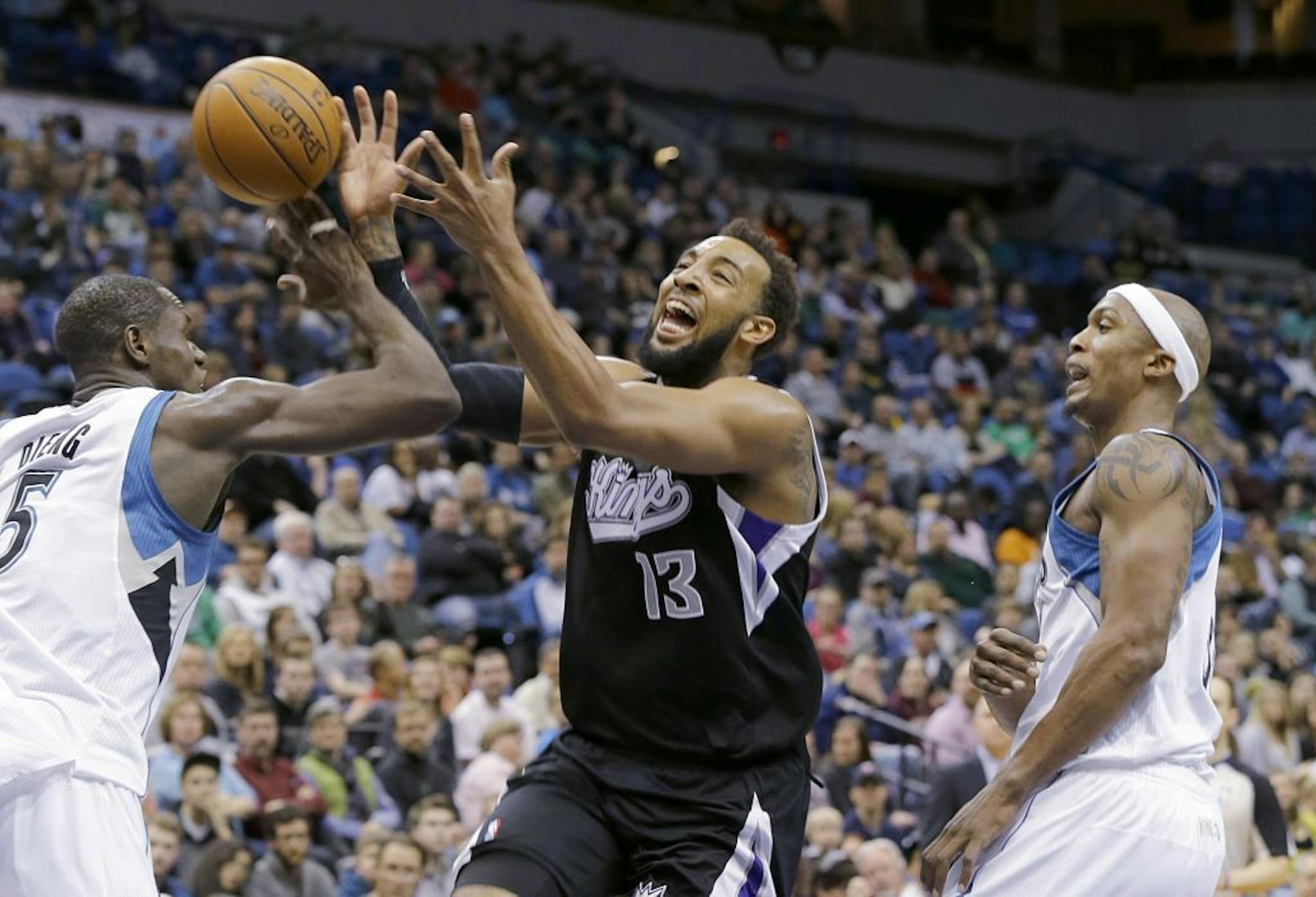 Timberwolves center Gorgui Dieng, left, stripped the ball from Kings forward Derrick Williams as Williams drove to the basket Sunday.